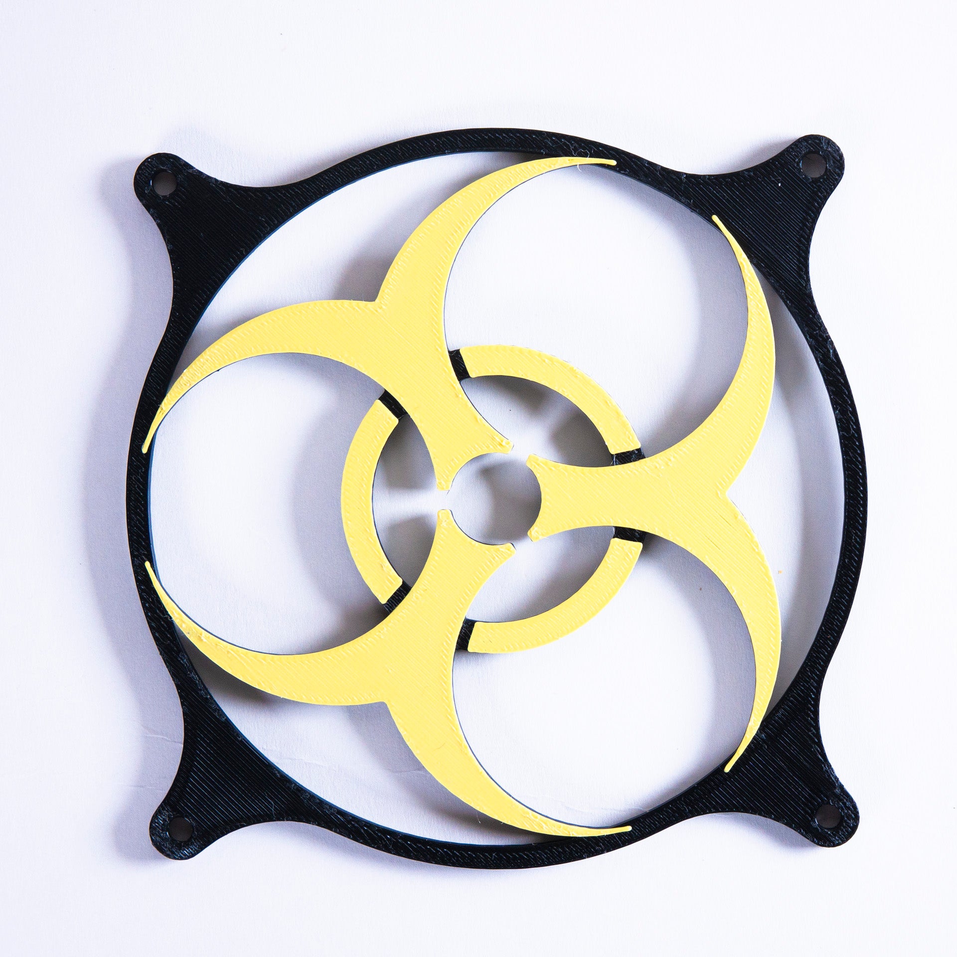 3D printed PC fan grill featuring a bold biohazard symbol. Perfect for custom gaming rigs, PC case mods, and fans of edgy, nerdy, or horror-inspired builds.