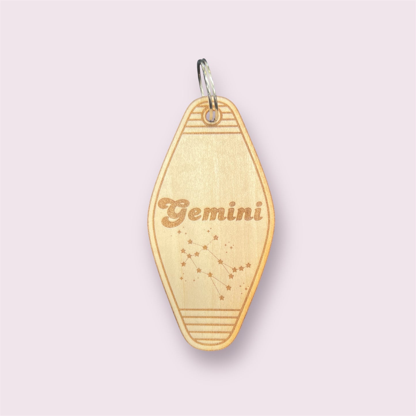 Laser engraved wood motel keychain featuring zodiac names and constellations, perfect for astrology lovers, horoscope fans, and retro gift collectors. This is for the Zodiac sign Gemini.