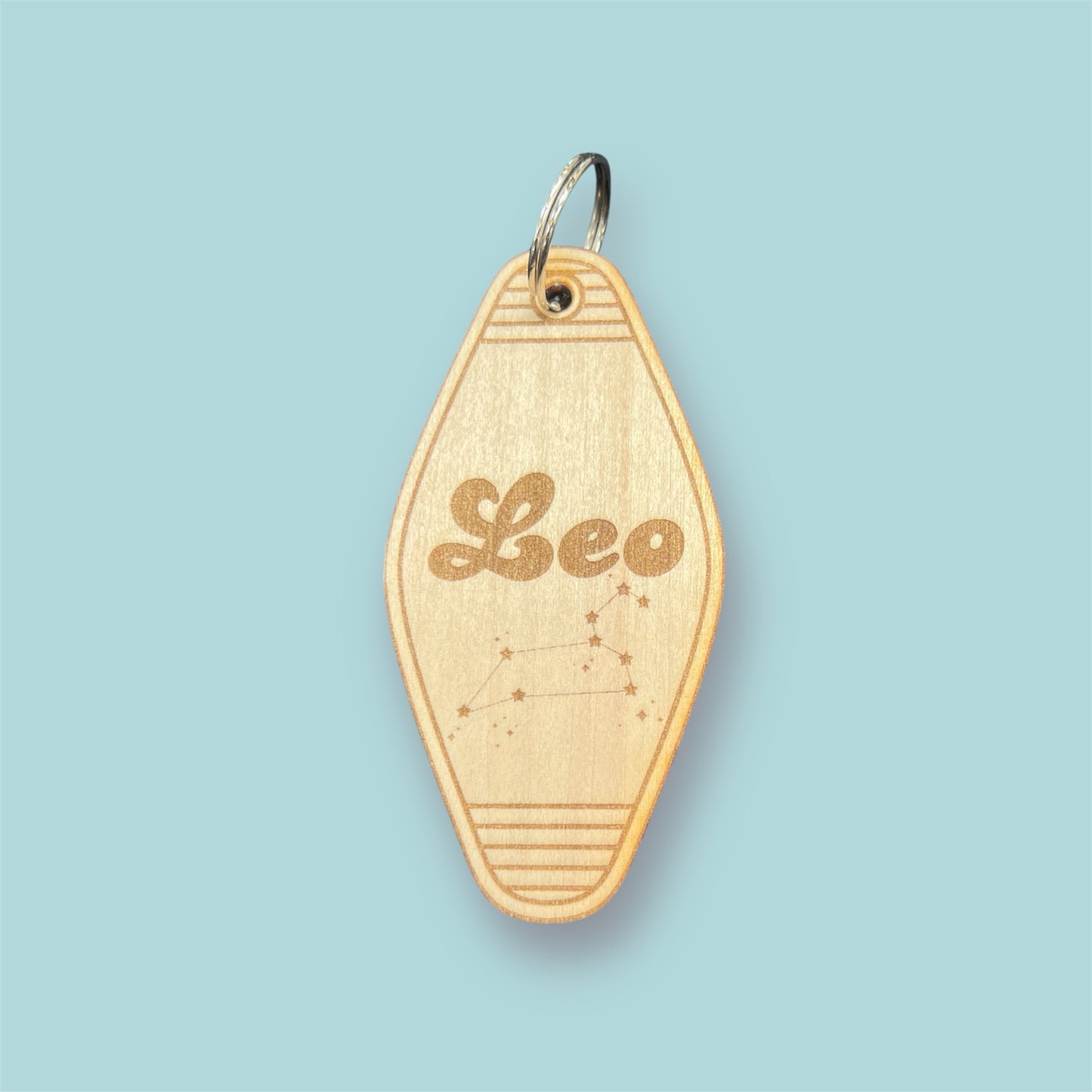 Laser engraved wood motel keychain featuring zodiac names and constellations, perfect for astrology lovers, horoscope fans, and retro gift collectors. This is for the Zodiac sign Leo.