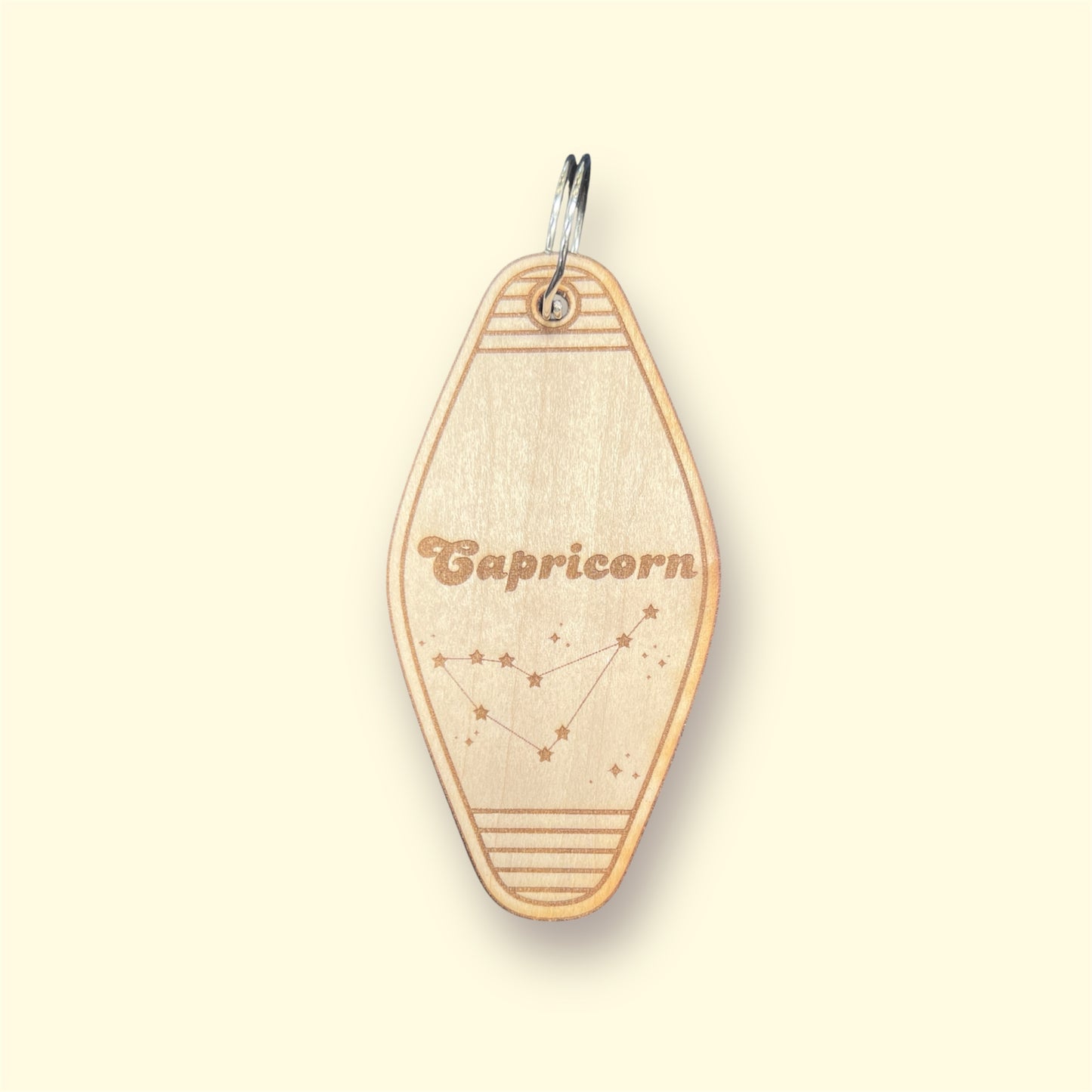 Laser engraved wood motel keychain featuring zodiac names and constellations, perfect for astrology lovers, horoscope fans, and retro gift collectors. This is for the Zodiac sign Capricorn.