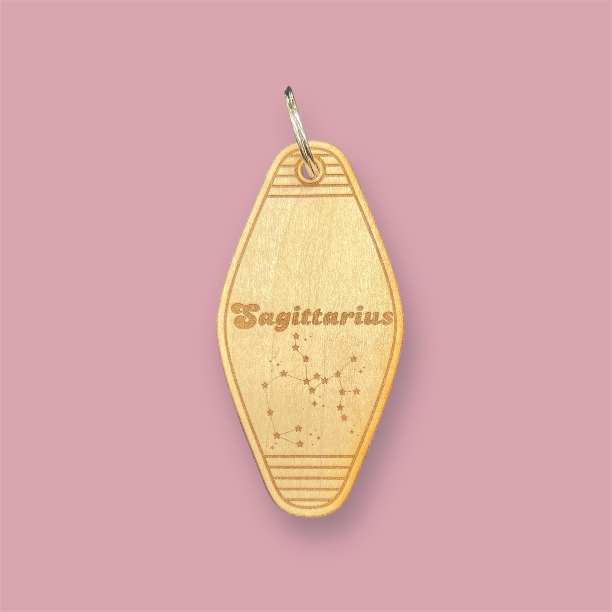 Laser engraved wood motel keychain featuring zodiac names and constellations, perfect for astrology lovers, horoscope fans, and retro gift collectors. This is for the Zodiac sign Sagittarius.