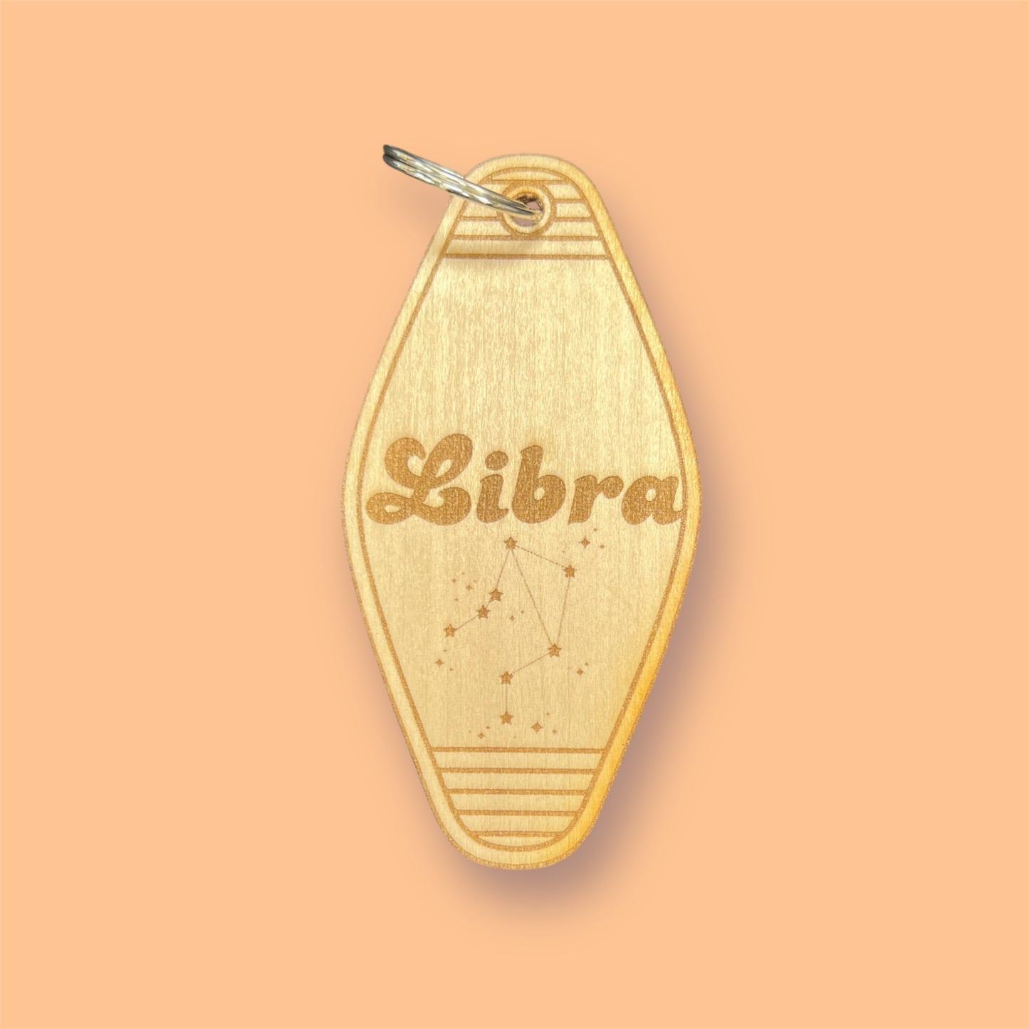 Laser engraved wood motel keychain featuring zodiac names and constellations, perfect for astrology lovers, horoscope fans, and retro gift collectors. This is for the Zodiac sign Libra.