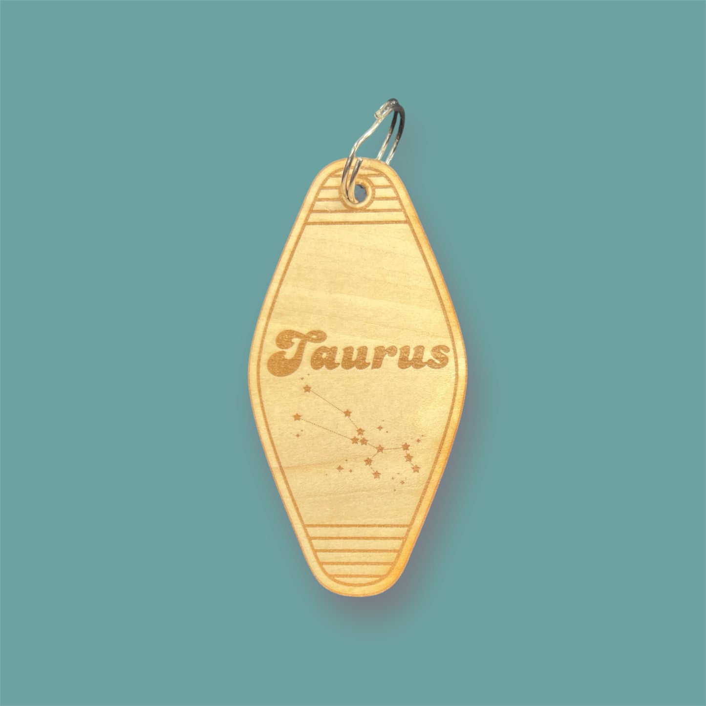 Laser engraved wood motel keychain featuring zodiac names and constellations, perfect for astrology lovers, horoscope fans, and retro gift collectors. This is for the Zodiac sign Taurus.