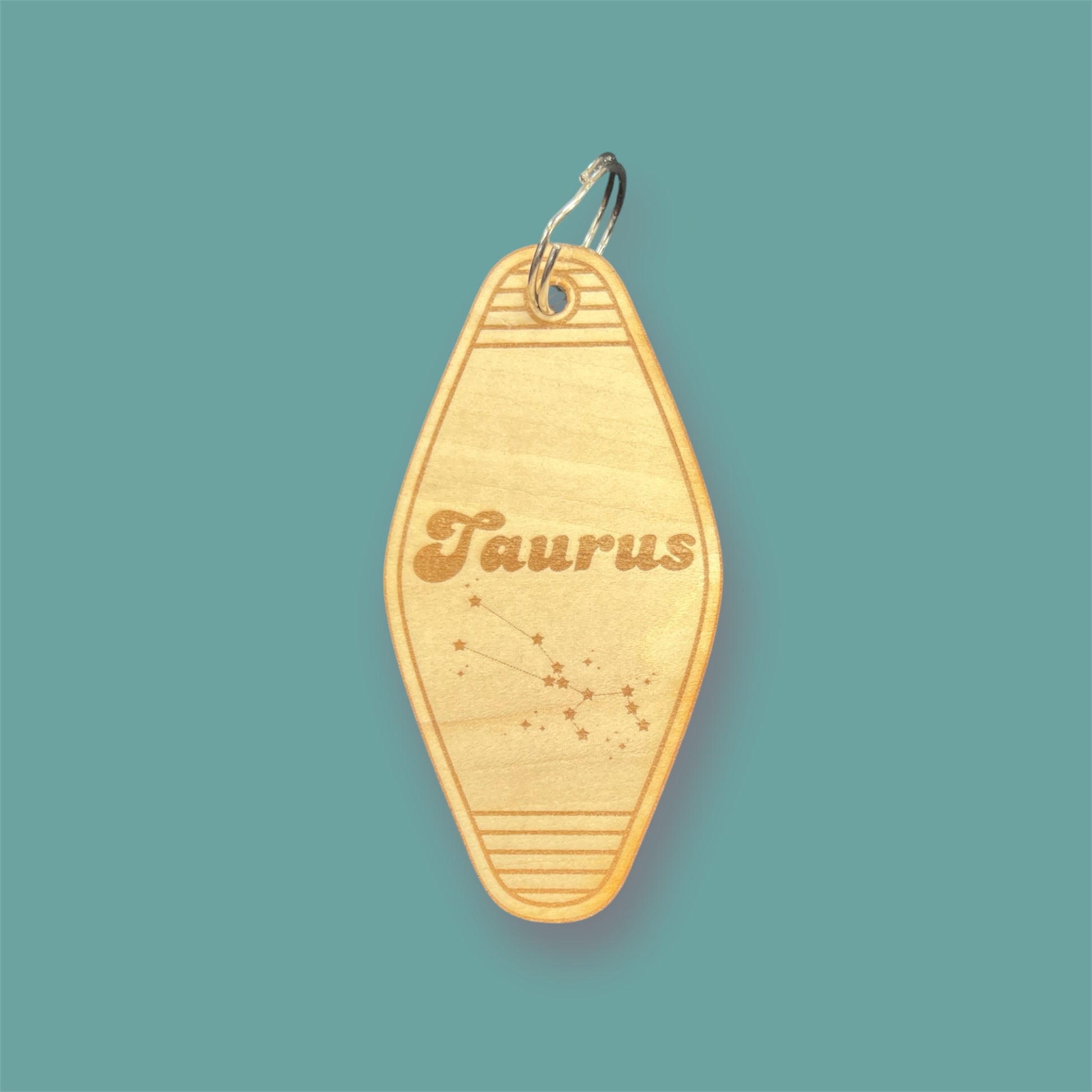 Laser engraved wood motel keychain featuring zodiac names and constellations, perfect for astrology lovers, horoscope fans, and retro gift collectors. This is for the Zodiac sign Taurus.