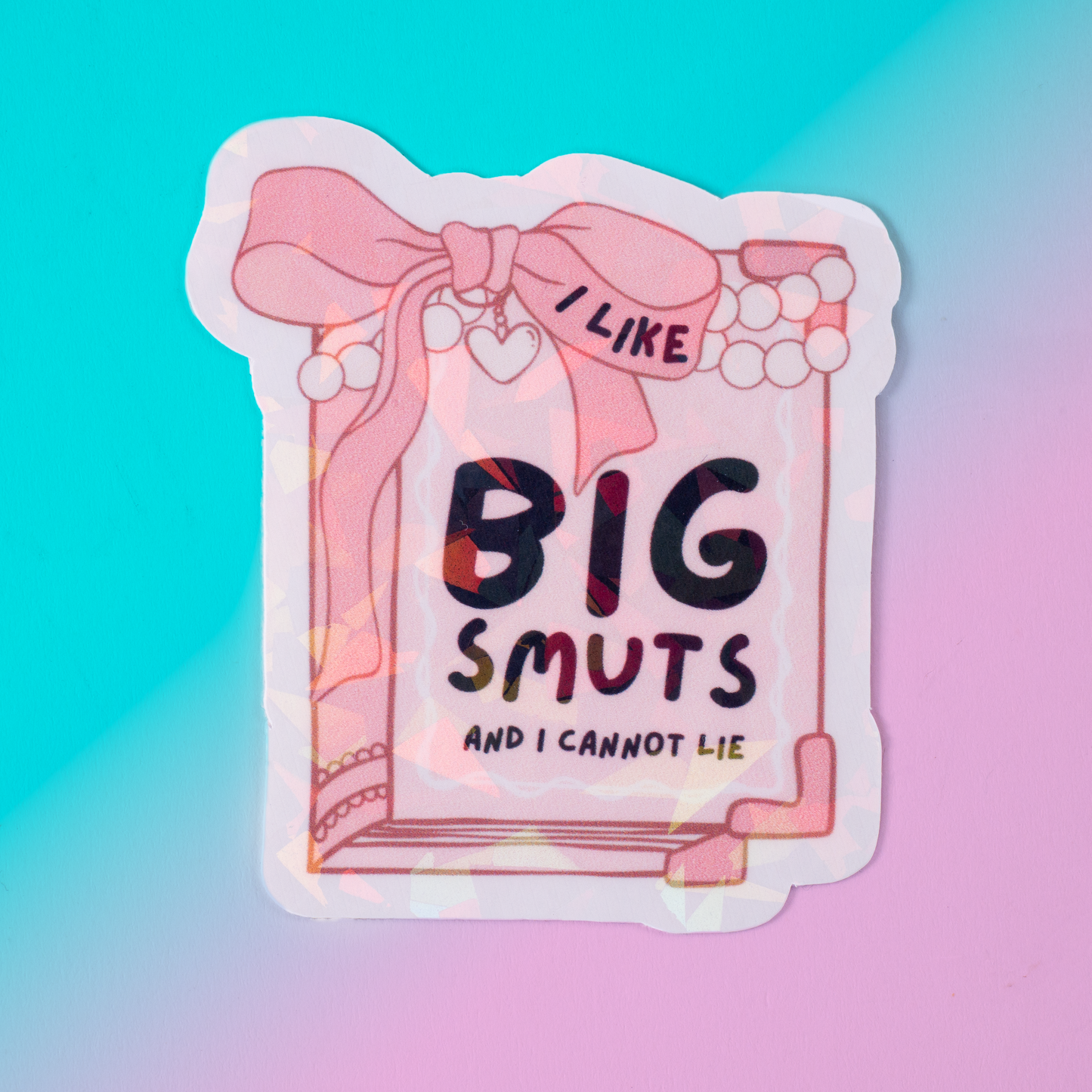Holographic vinyl sticker featuring a pink book with pearls and the phrase I Like Big Smuts and I Cannot Lie. Perfect for romance book lovers, spicy book readers, and bookish aesthetic fans.