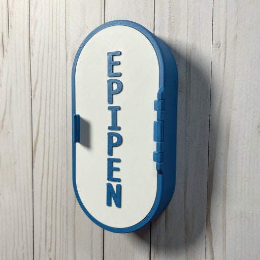 Wall-mounted, blue and white EpiPen storage case designed for easy access in emergencies. Durable, sleek, and perfect for mounting on walls in homes, offices, or schools for safe storage of epinephrine injectors.