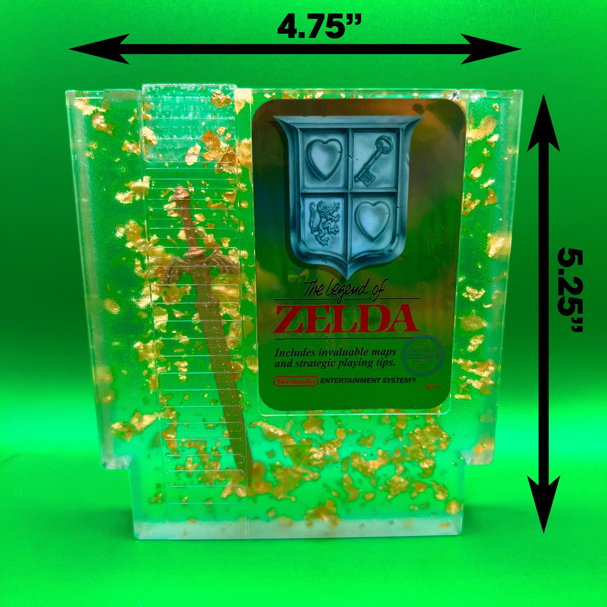 Legend of Zelda resin art featuring a retro NES cartridge with a gold sword design and gold flakes embedded. This handmade display is perfect for gamers and video game collectors, offering a unique décor piece for any gaming setup or retro collection