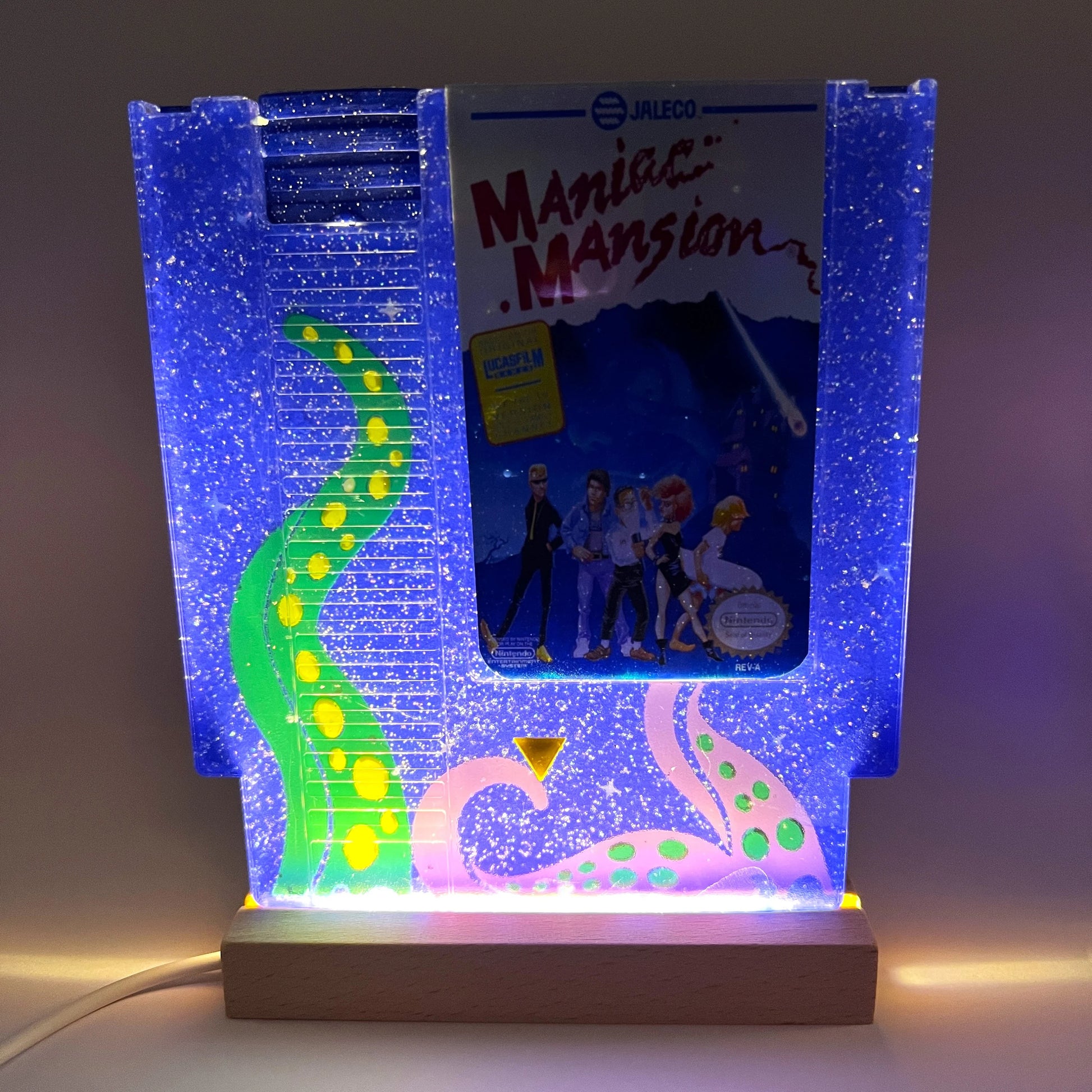 Handmade custom Maniac Mansion NES cartridge art, featuring a starry night background and iconic tentacles from the game. Perfect for displaying as unique gamer decor or a gift for retro game enthusiasts.