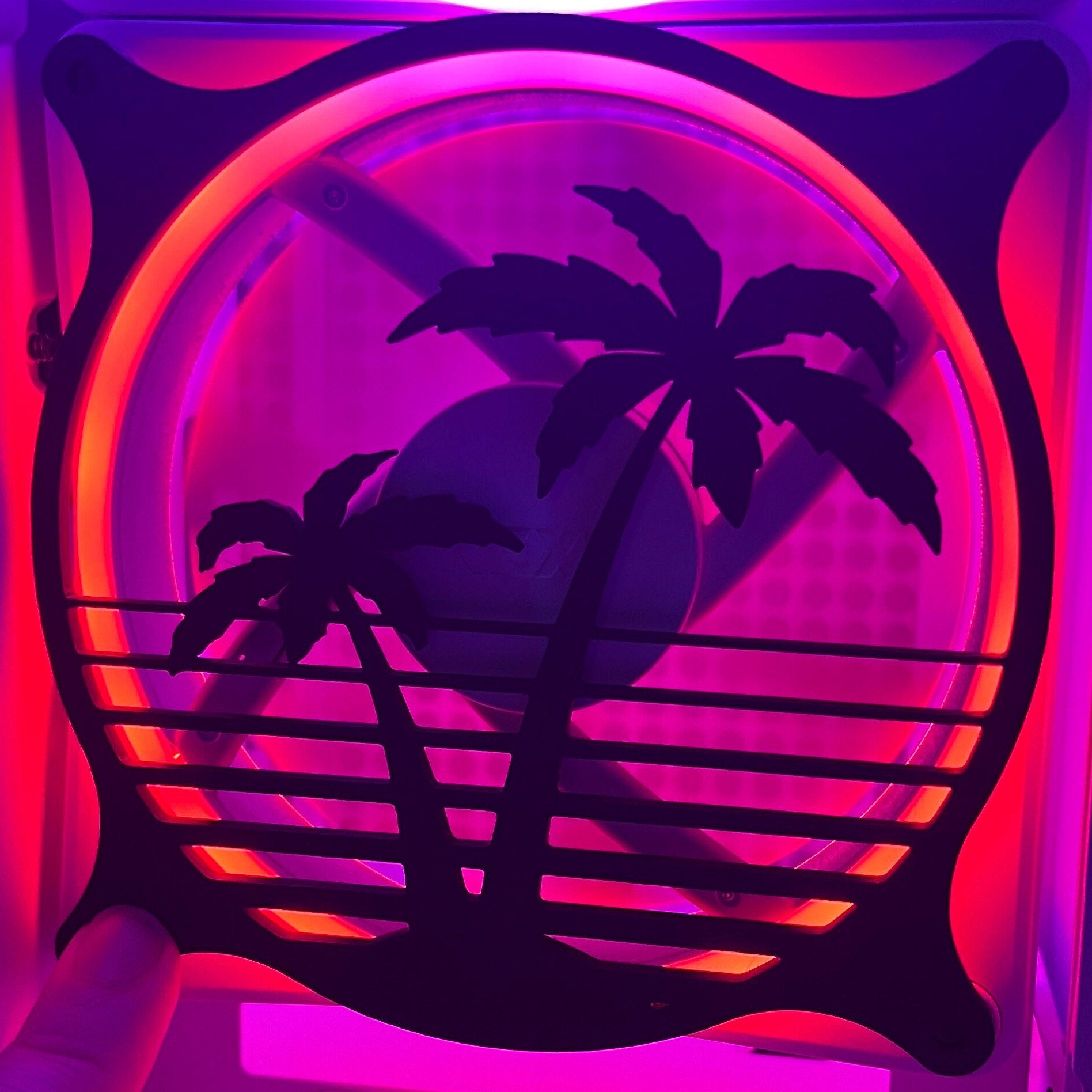 Decorative PC fan cover featuring an 80s tropical palm tree design with a black textured finish. Perfect for adding a unique and stylish touch to gaming or custom PC builds, blending functionality with aesthetic flair.
