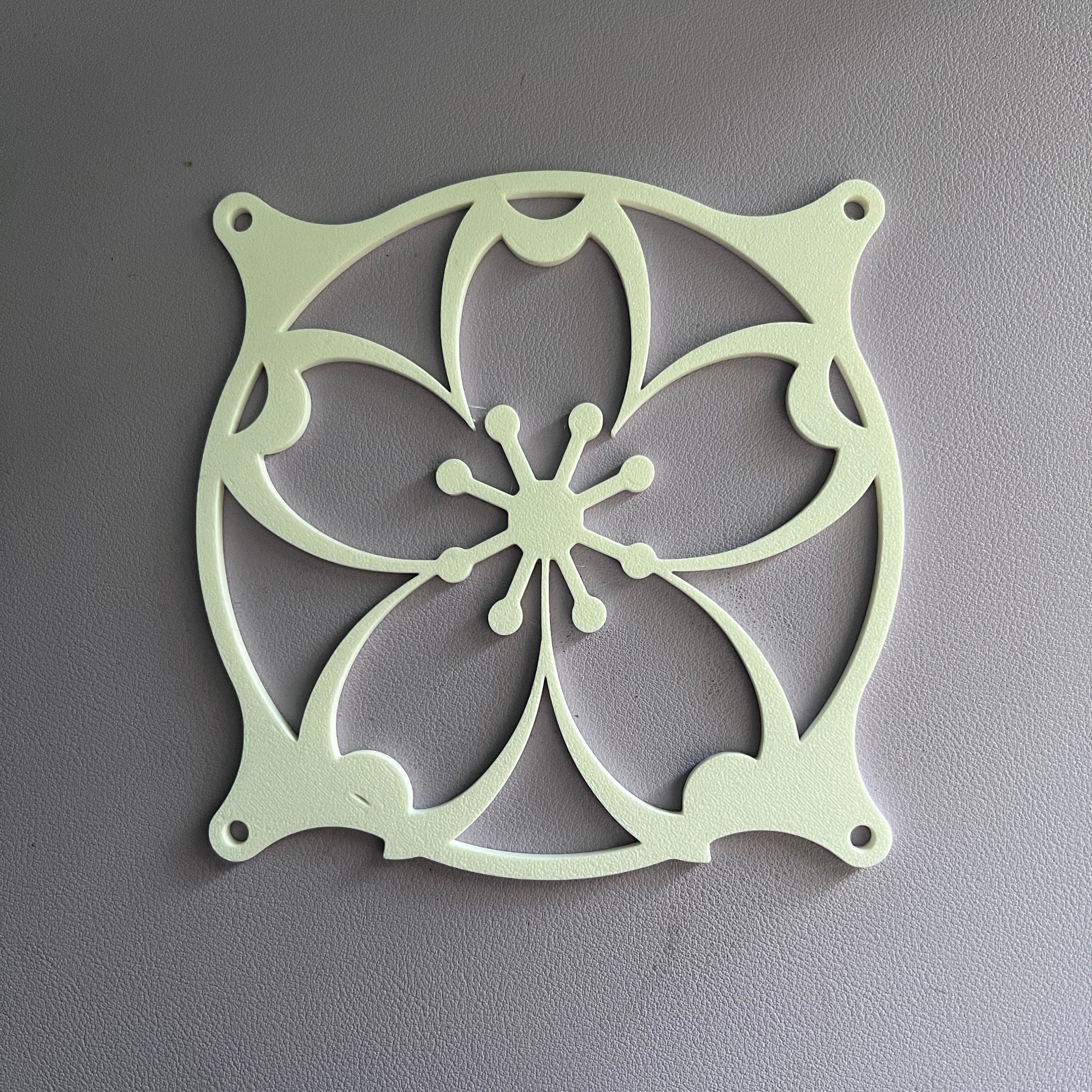 Whimsical cherry blossom fan grill designed for PC cases. Fits standard computer fans and adds a subtle floral touch to your computer setup with its sakura-inspired pattern. Perfect for aesthetic upgrades.