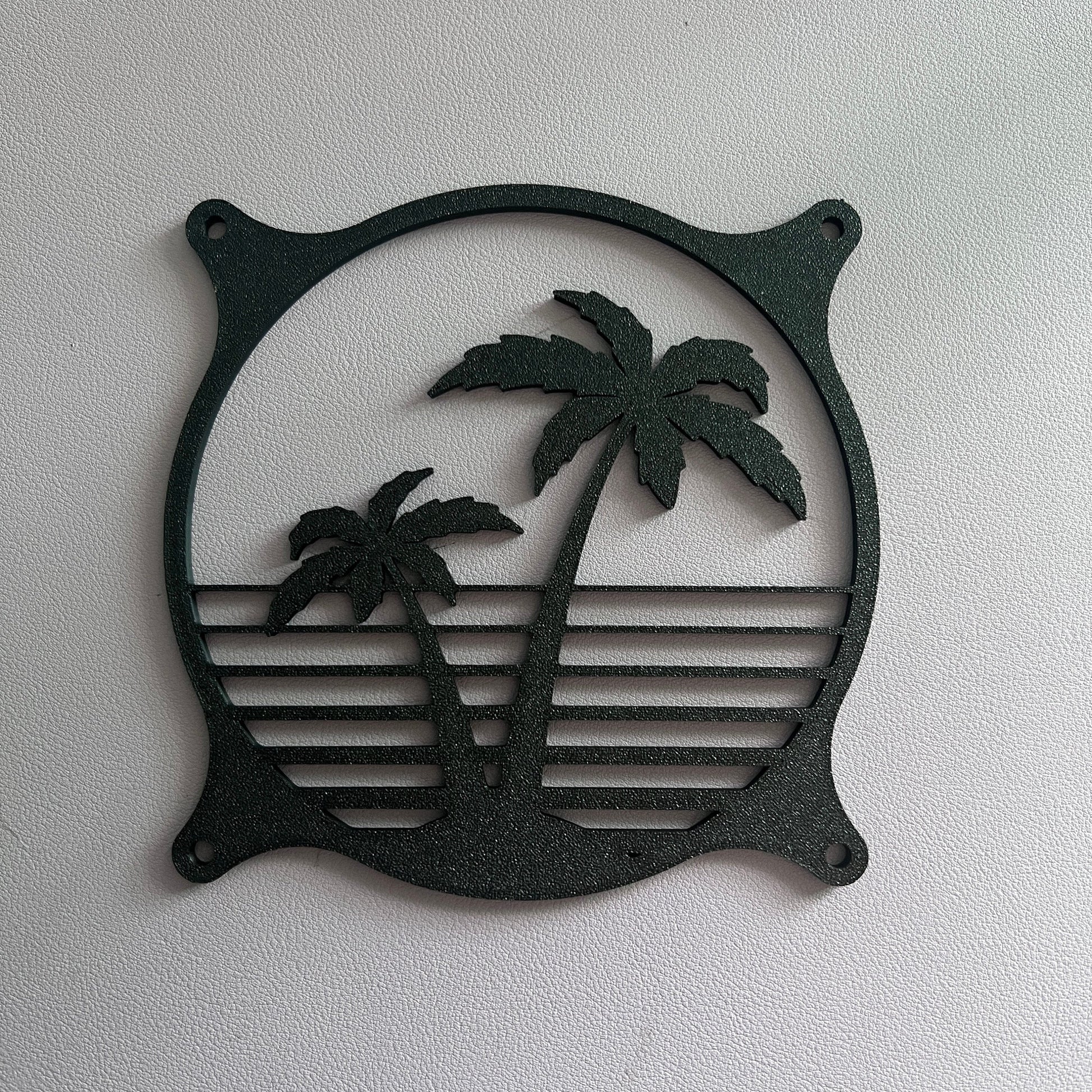 Decorative PC fan cover featuring an 80s tropical palm tree design with a black textured finish. Perfect for adding a unique and stylish touch to gaming or custom PC builds, blending functionality with aesthetic flair.