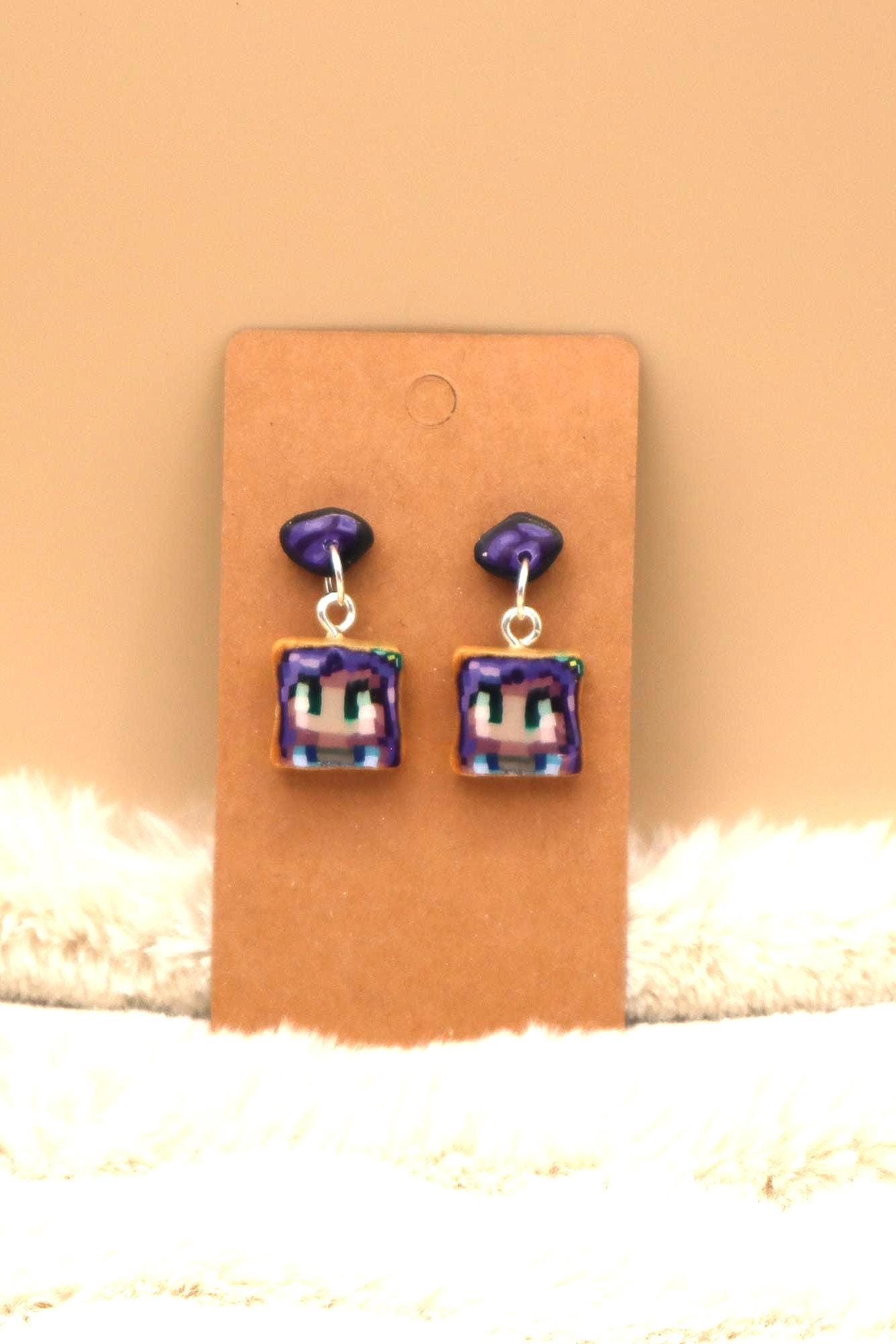 Handmade dangle earrings inspired by Abigail’s love of amethysts in Stardew Valley. Perfect gamer girl gift, cosplay jewelry, or crystal fan accessory.