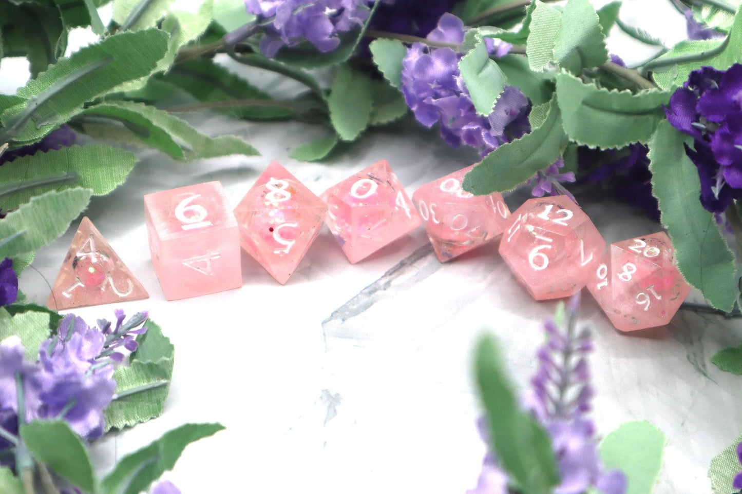 Handmade pink and white glitter liquid core resin dice set with shimmer effect, perfect for DnD, TTRPG players, and fantasy-themed gaming sessions.