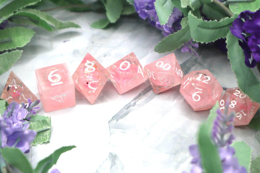 Handmade pink and white glitter liquid core resin dice set with shimmer effect, perfect for DnD, TTRPG players, and fantasy-themed gaming sessions.
