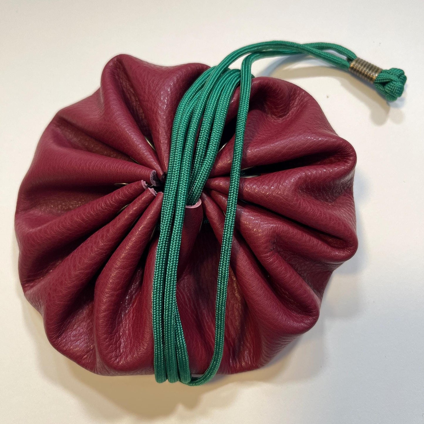 Handcrafted leather dice bag with drawstring, ideal for storing RPG dice sets. Perfect for DnD, tabletop games, or as a fantasy gift for gamers.
