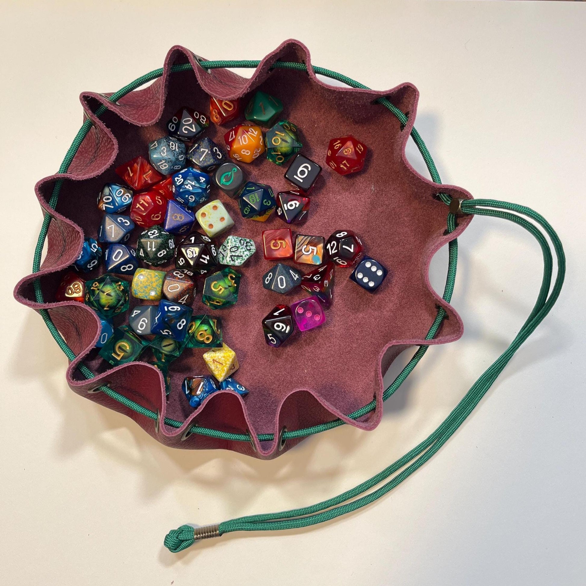Handcrafted leather dice bag with drawstring, ideal for storing RPG dice sets. Perfect for DnD, tabletop games, or as a fantasy gift for gamers.