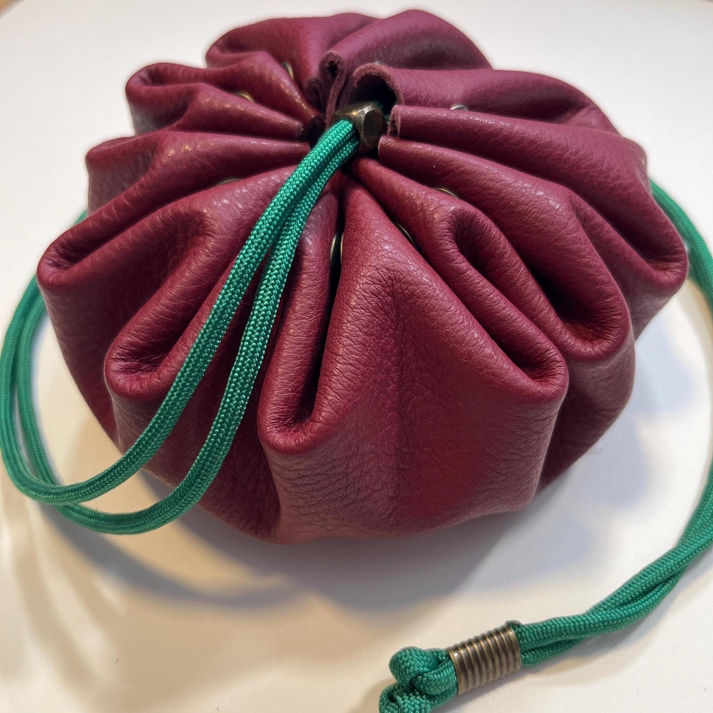 Handcrafted leather dice bag with drawstring, ideal for storing RPG dice sets. Perfect for DnD, tabletop games, or as a fantasy gift for gamers.