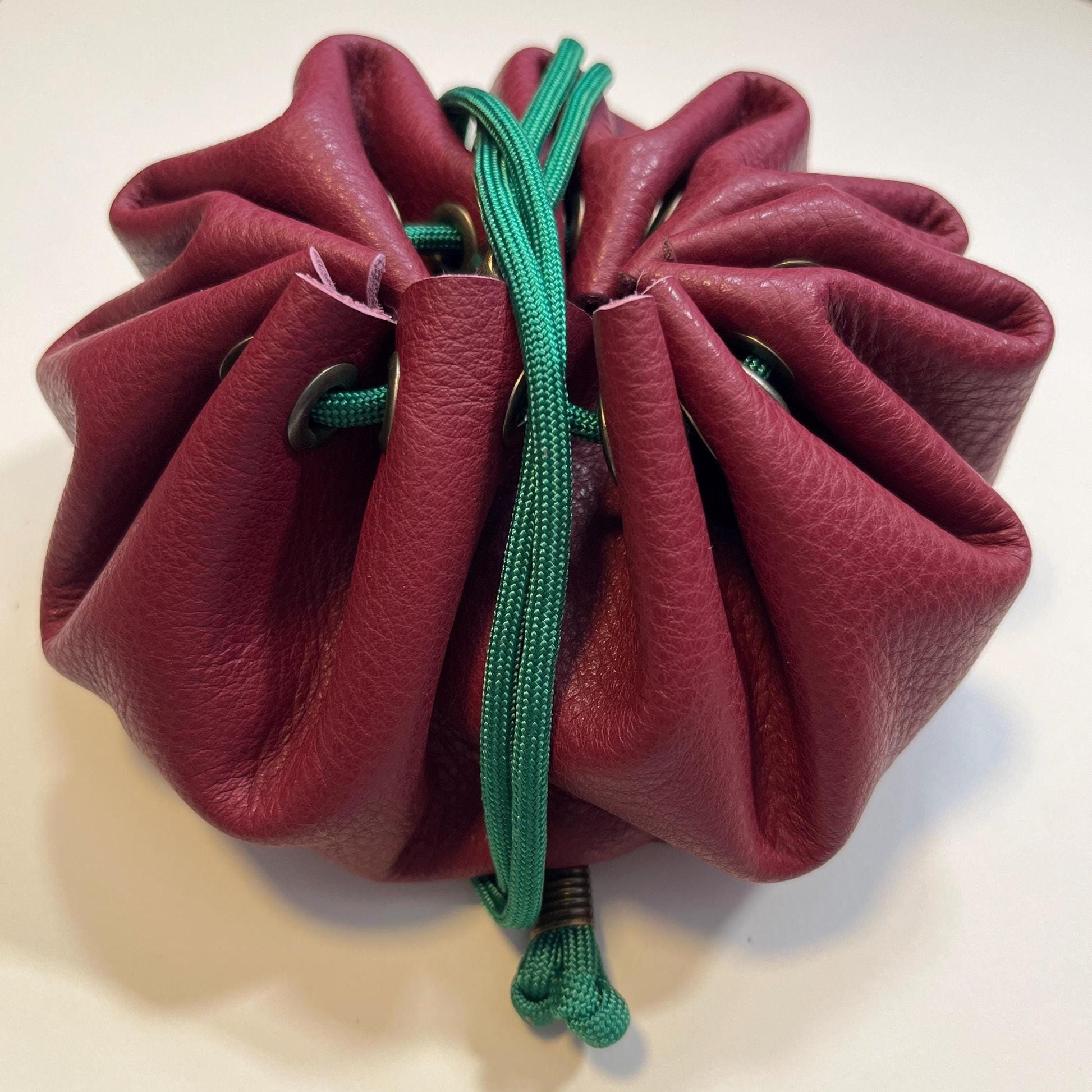 Handcrafted leather dice bag with drawstring, ideal for storing RPG dice sets. Perfect for DnD, tabletop games, or as a fantasy gift for gamers.