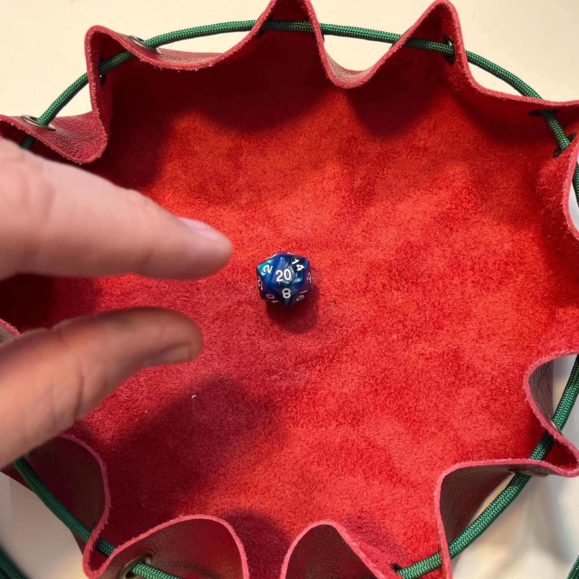 Action shot of rolling a D20 into the bag tray. Handmade potato-colored leather dice bag for RPG games like D&D. Durable pouch for tabletop gamers and collectors. Unique gift for role-playing game lovers.