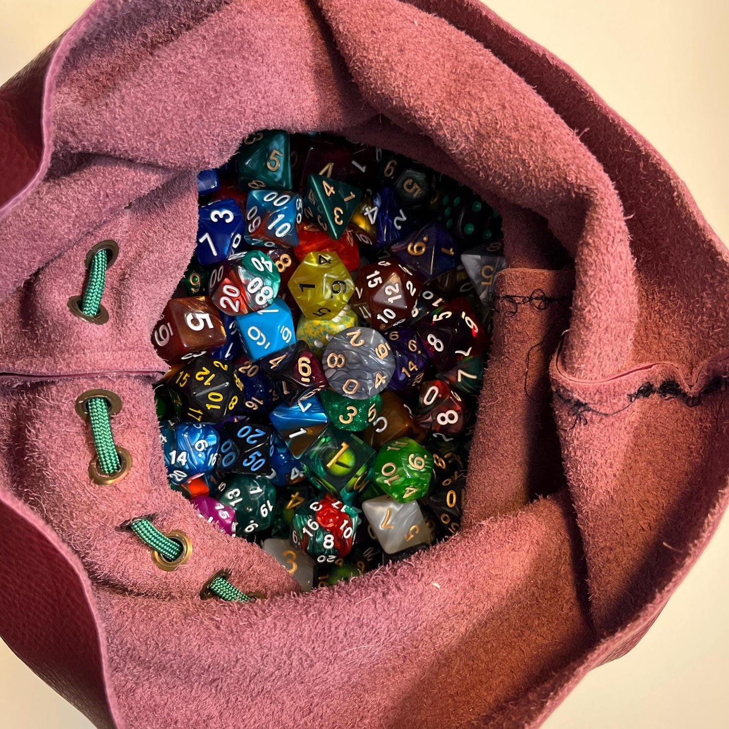 Handcrafted leather dice bag with drawstring, ideal for storing RPG dice sets. Perfect for DnD, tabletop games, or as a fantasy gift for gamers.
