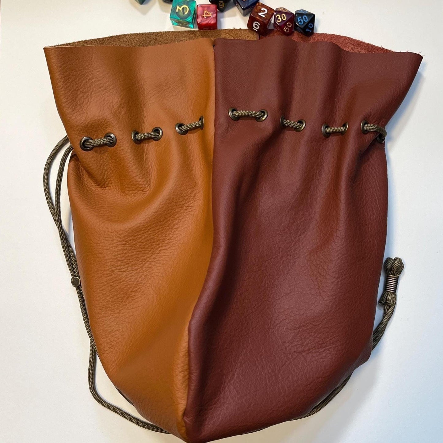 Handcrafted leather dice bag with drawstring, ideal for storing RPG dice sets. Perfect for DnD, tabletop games, or as a fantasy gift for gamers.