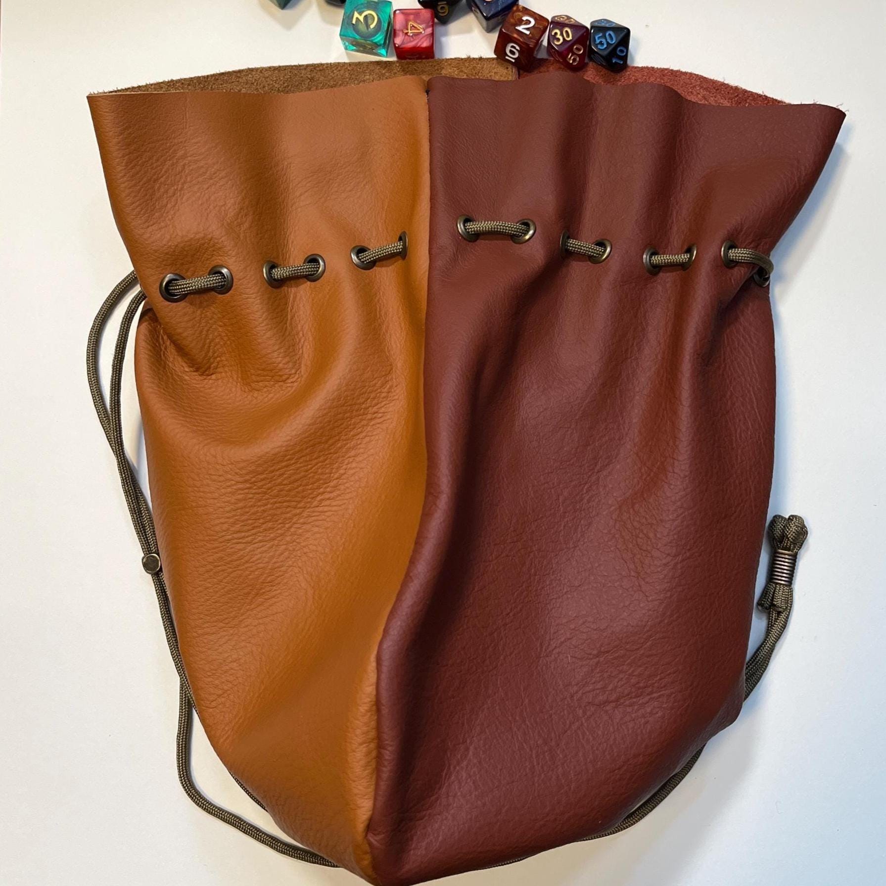 Handcrafted leather dice bag with drawstring, ideal for storing RPG dice sets. Perfect for DnD, tabletop games, or as a fantasy gift for gamers.