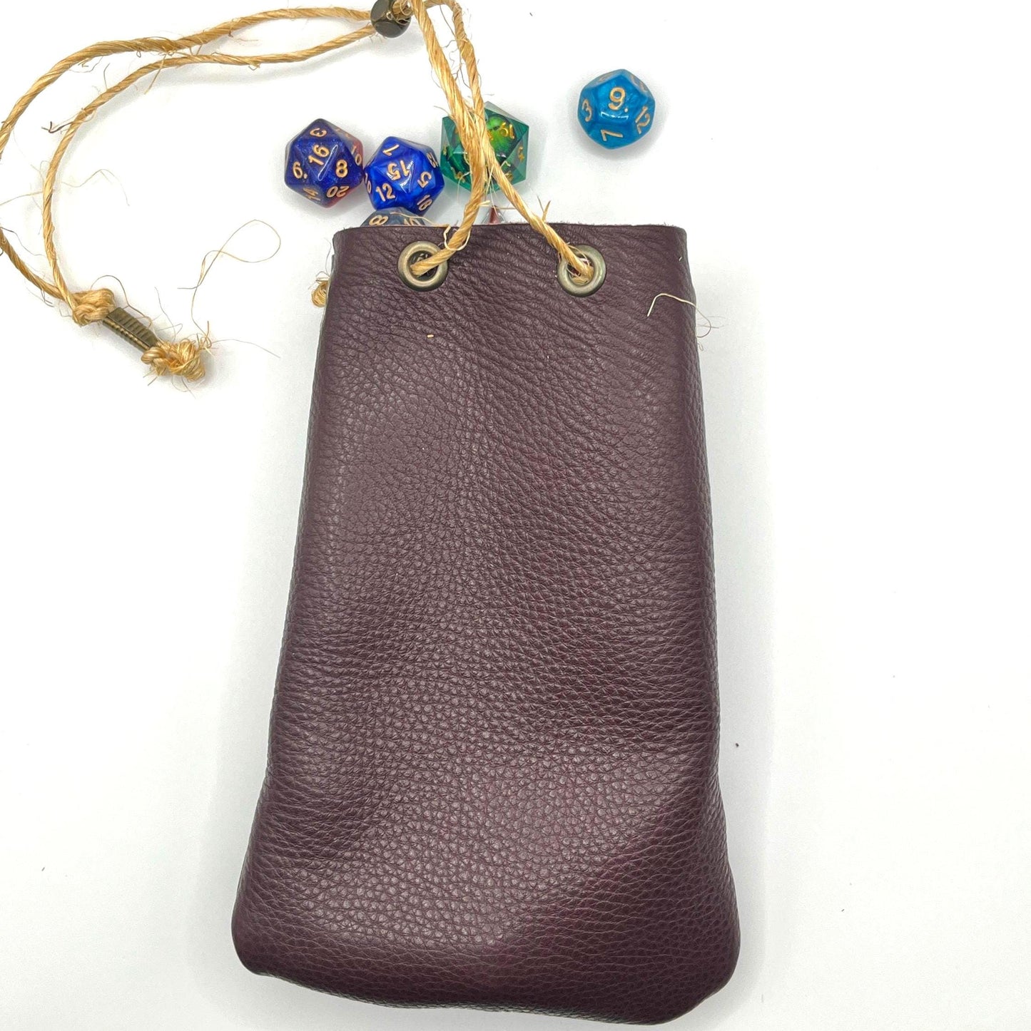 Handcrafted leather dice bag with drawstring, ideal for storing RPG dice sets. Perfect for DnD, tabletop games, or as a fantasy gift for gamers.