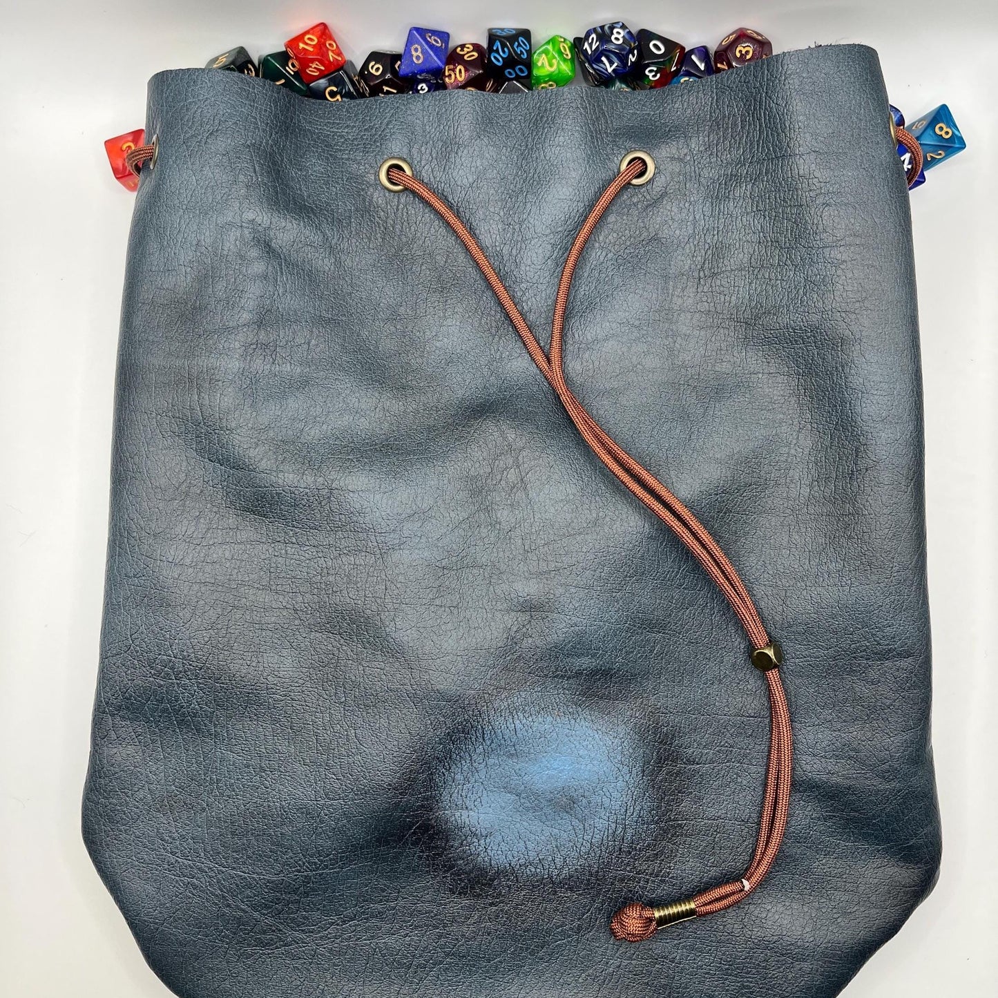 Handcrafted leather dice bag with drawstring, ideal for storing RPG dice sets. Perfect for DnD, tabletop games, or as a fantasy gift for gamers.