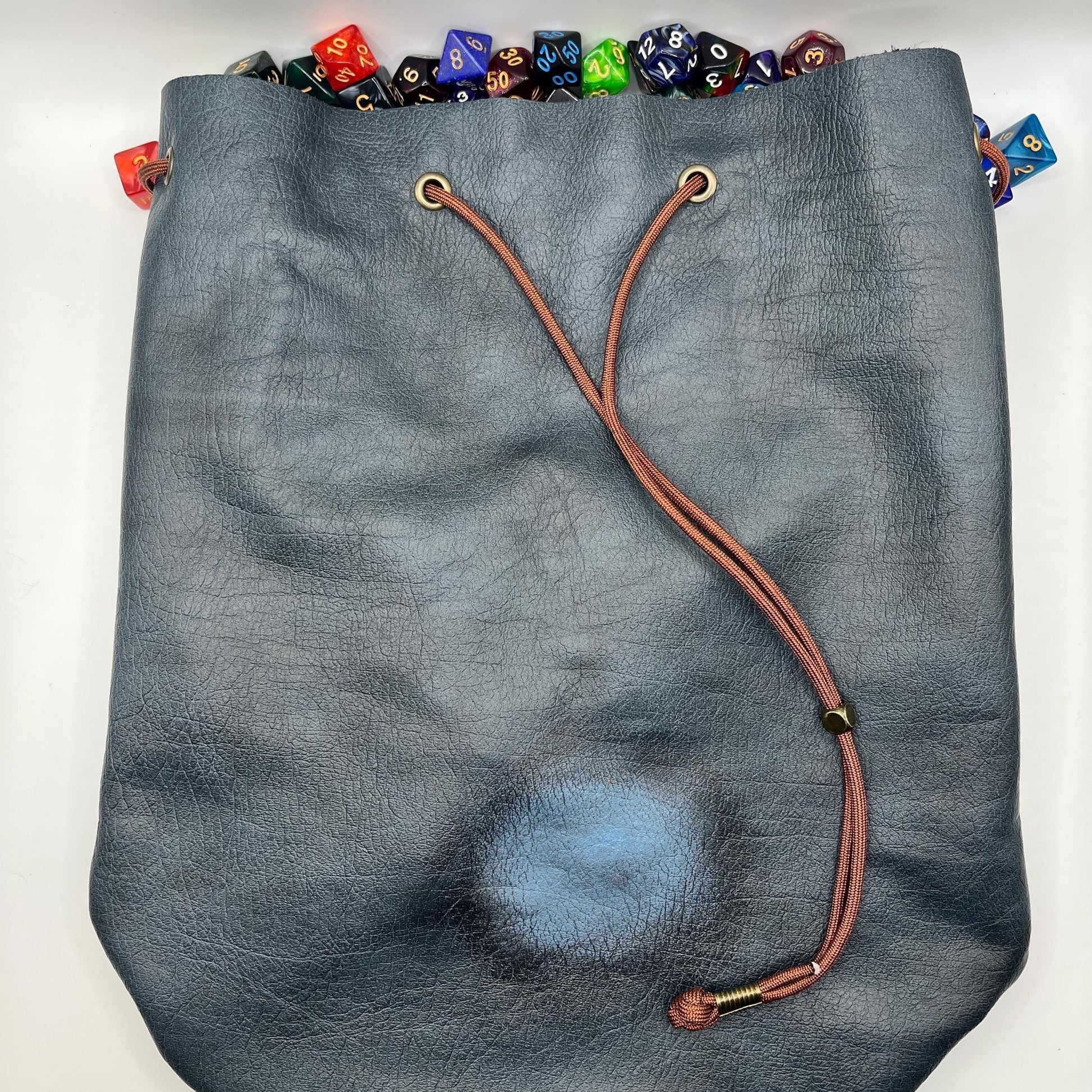 Handcrafted leather dice bag with drawstring, ideal for storing RPG dice sets. Perfect for DnD, tabletop games, or as a fantasy gift for gamers.