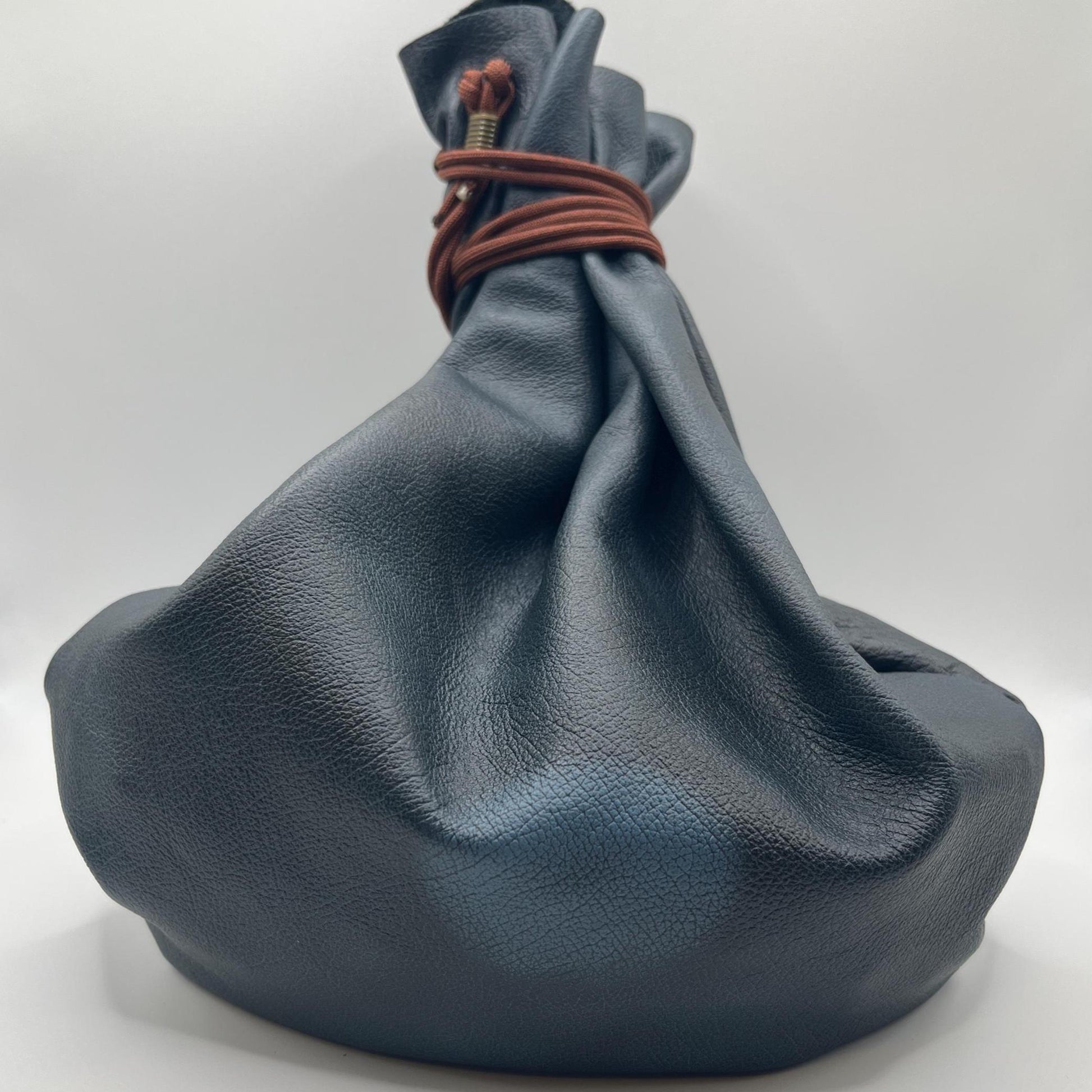 Handcrafted leather dice bag with drawstring, ideal for storing RPG dice sets. Perfect for DnD, tabletop games, or as a fantasy gift for gamers.