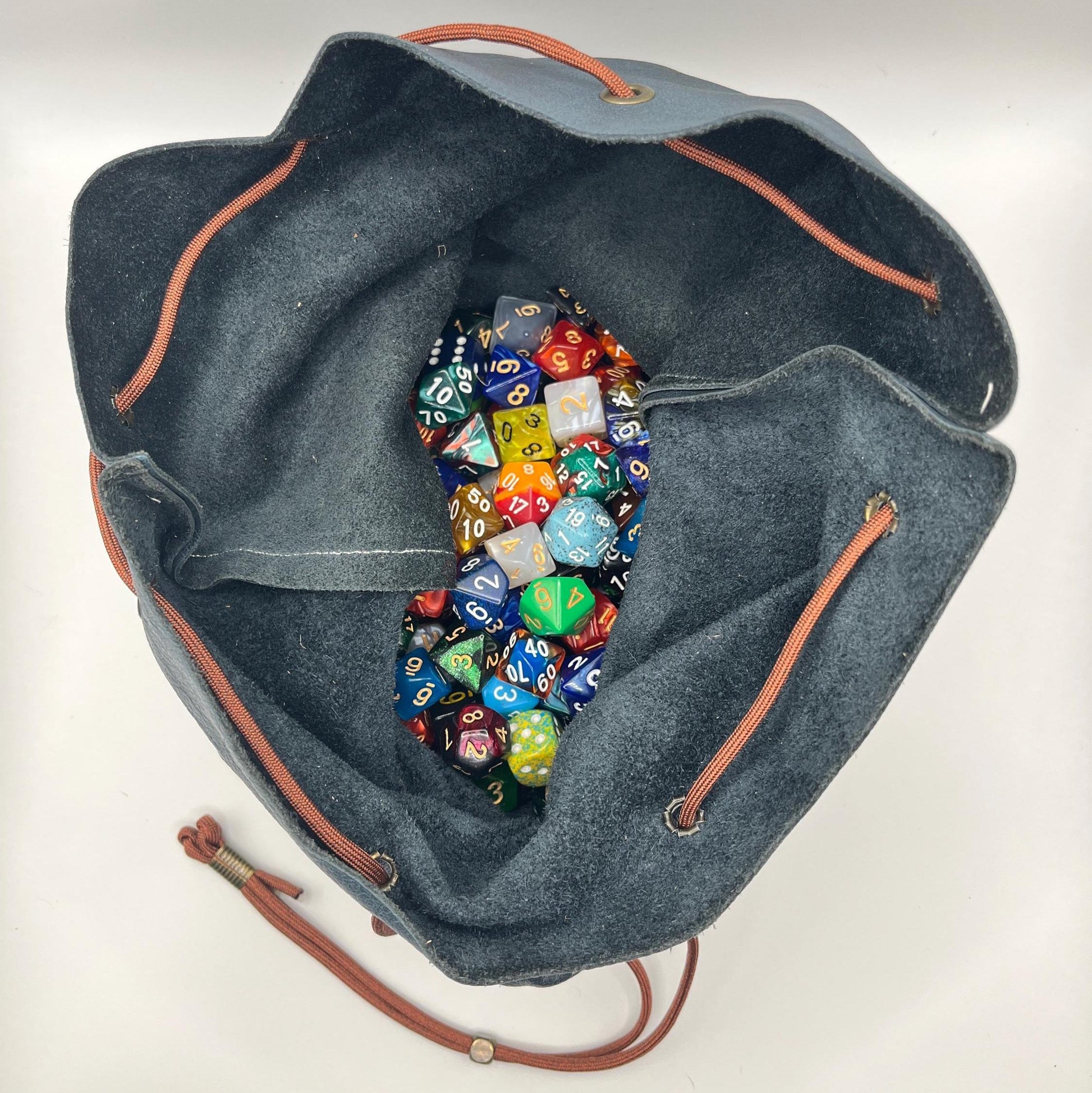 Handcrafted leather dice bag with drawstring, ideal for storing RPG dice sets. Perfect for DnD, tabletop games, or as a fantasy gift for gamers.