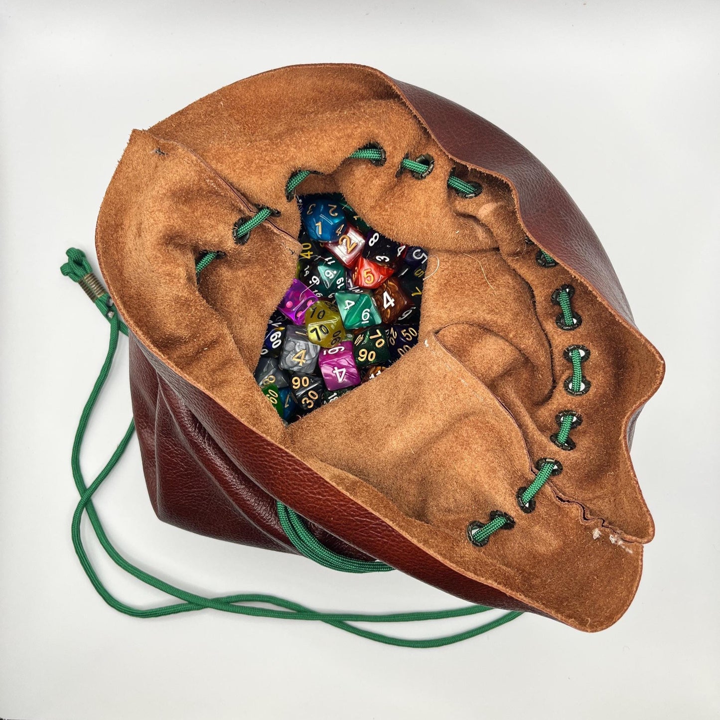 Handcrafted leather dice bag with drawstring, ideal for storing RPG dice sets. Perfect for DnD, tabletop games, or as a fantasy gift for gamers.