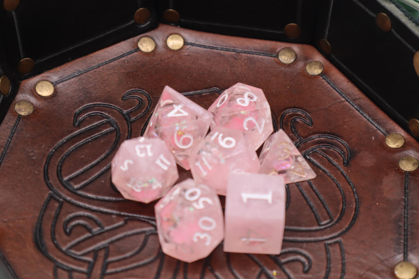 Handmade pink and white glitter liquid core resin dice set with shimmer effect, perfect for DnD, TTRPG players, and fantasy-themed gaming sessions.