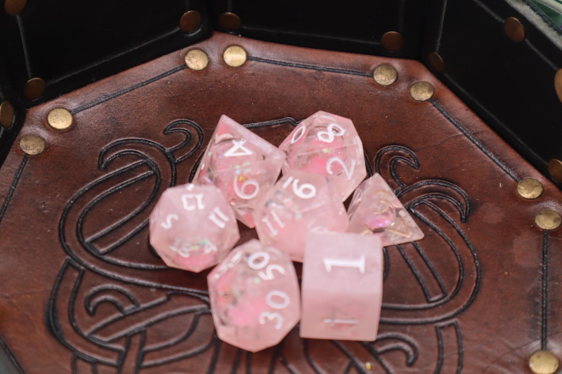 Handmade pink and white glitter liquid core resin dice set with shimmer effect, perfect for DnD, TTRPG players, and fantasy-themed gaming sessions.