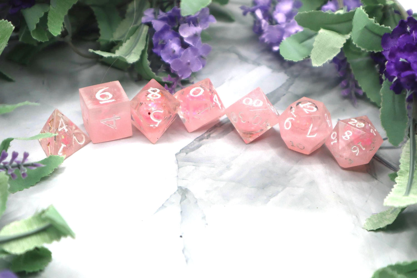 Handmade pink and white glitter liquid core resin dice set with shimmer effect, perfect for DnD, TTRPG players, and fantasy-themed gaming sessions.