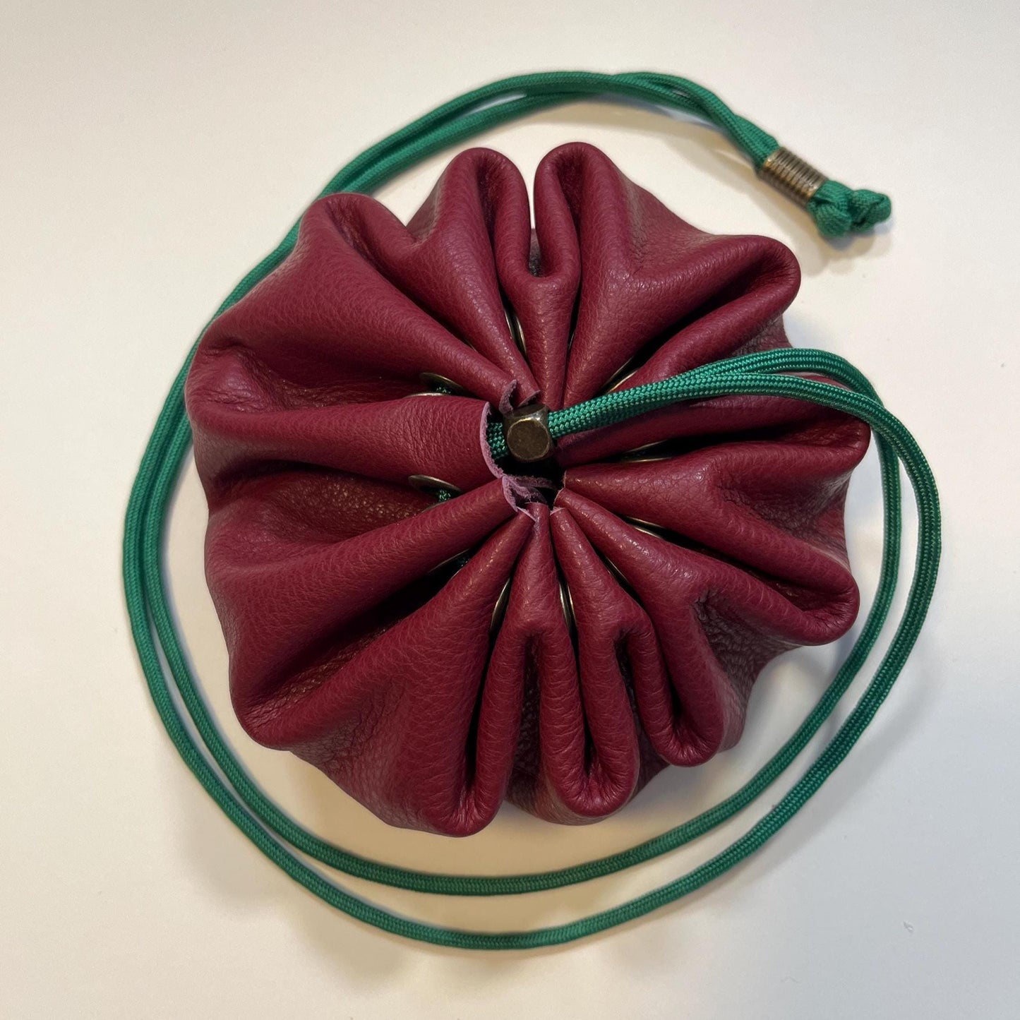 Handcrafted leather dice bag with drawstring, ideal for storing RPG dice sets. Perfect for DnD, tabletop games, or as a fantasy gift for gamers.