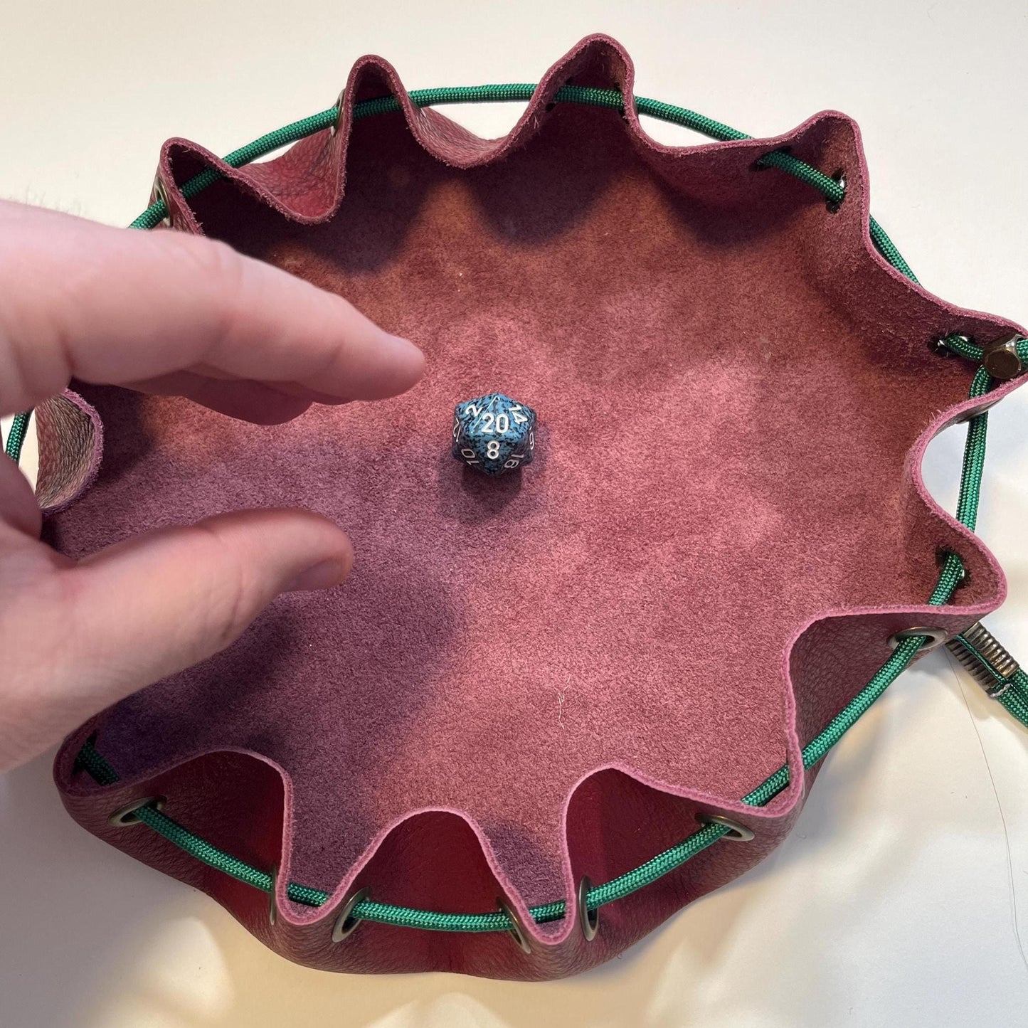 Handcrafted leather dice bag with drawstring, ideal for storing RPG dice sets. Perfect for DnD, tabletop games, or as a fantasy gift for gamers.