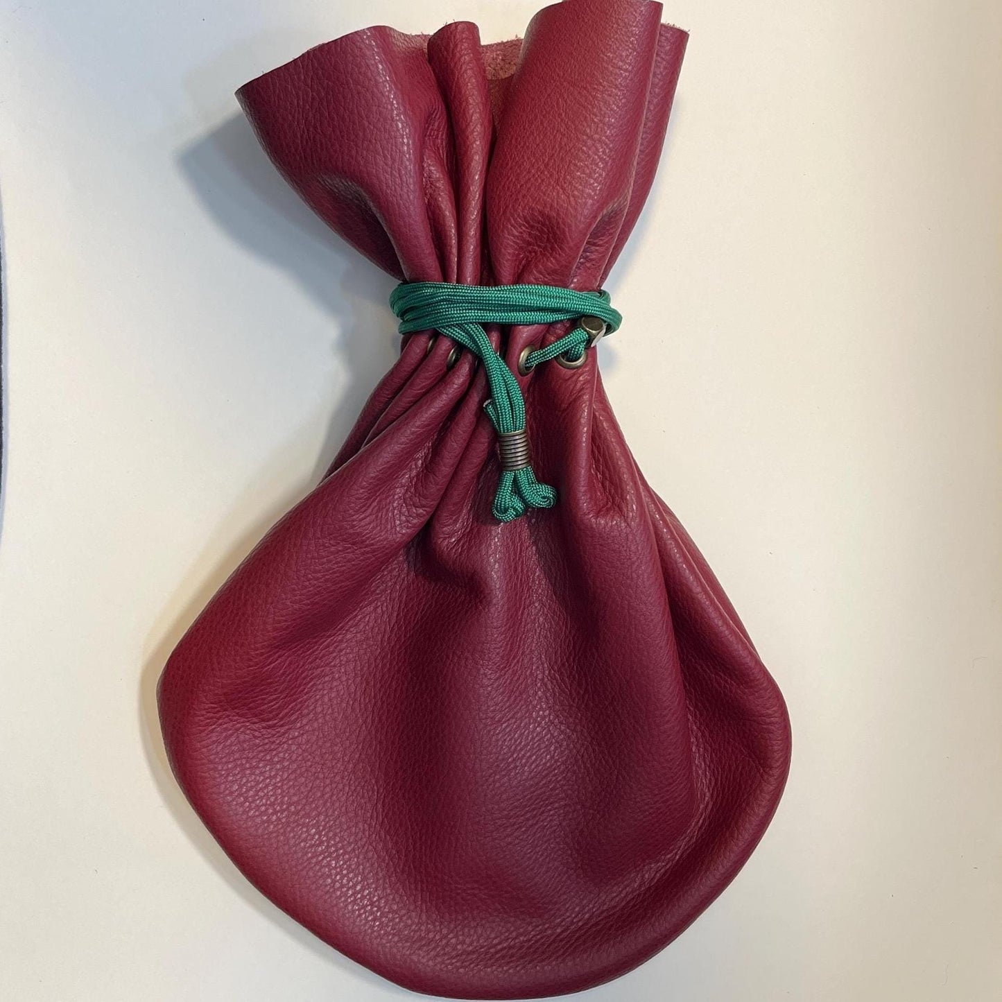 Handcrafted leather dice bag with drawstring, ideal for storing RPG dice sets. Perfect for DnD, tabletop games, or as a fantasy gift for gamers.