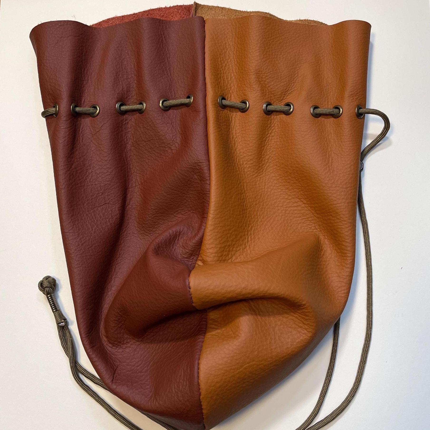 Handcrafted leather dice bag with drawstring, ideal for storing RPG dice sets. Perfect for DnD, tabletop games, or as a fantasy gift for gamers.