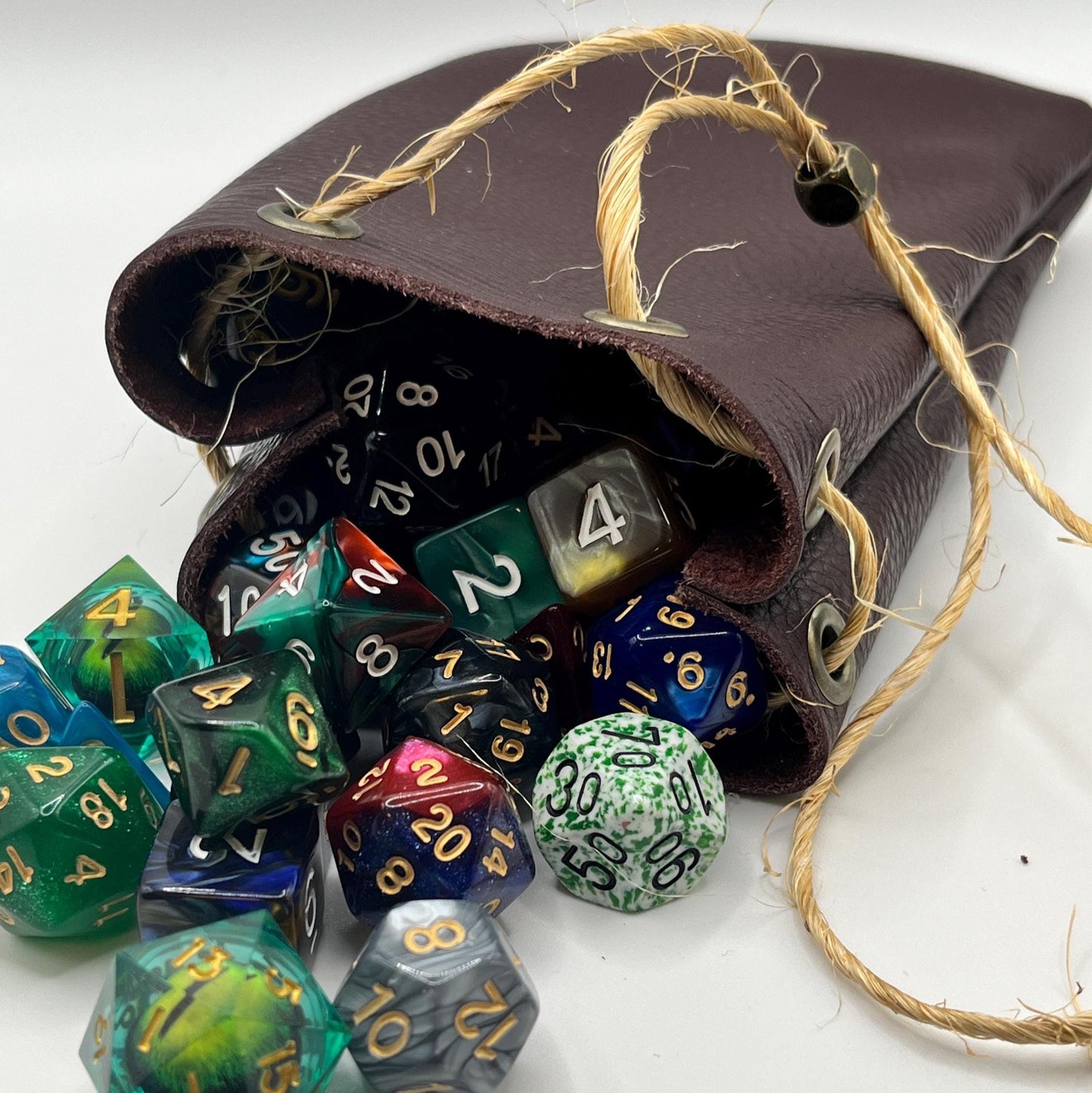 Handcrafted leather dice bag with drawstring, ideal for storing RPG dice sets. Perfect for DnD, tabletop games, or as a fantasy gift for gamers.