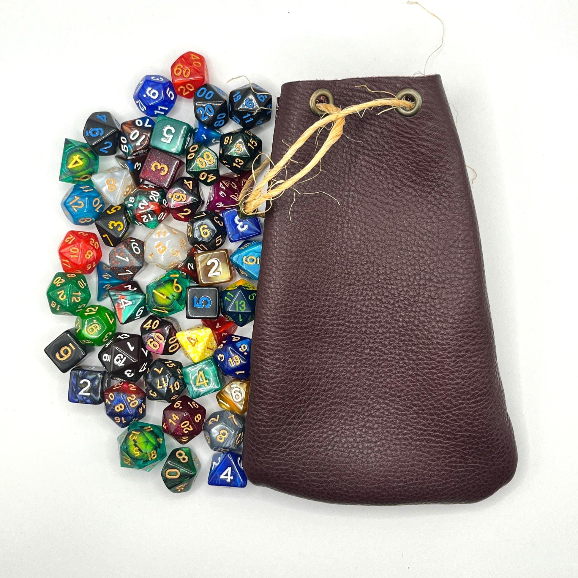 Handcrafted leather dice bag with drawstring, ideal for storing RPG dice sets. Perfect for DnD, tabletop games, or as a fantasy gift for gamers.