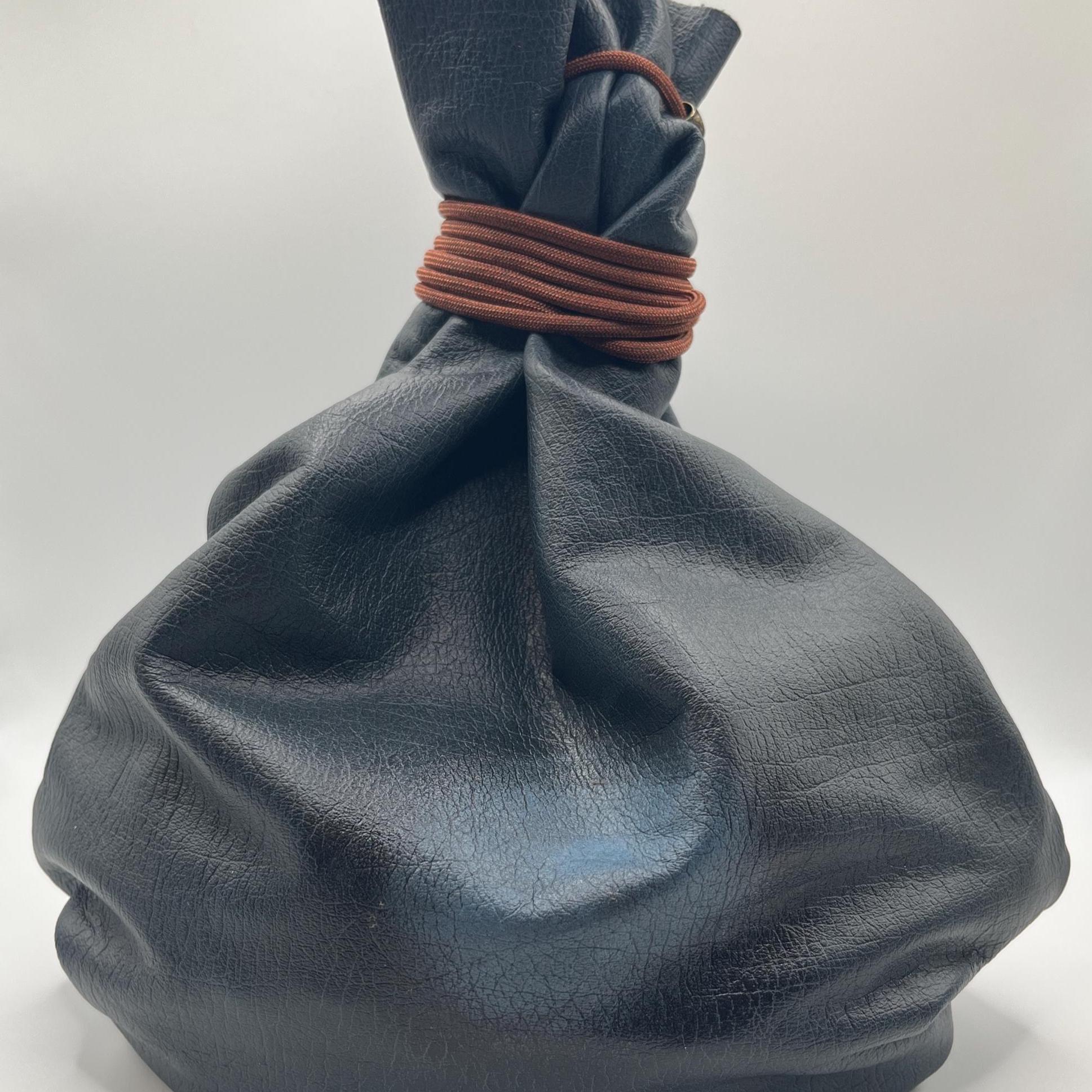 Handcrafted leather dice bag with drawstring, ideal for storing RPG dice sets. Perfect for DnD, tabletop games, or as a fantasy gift for gamers.