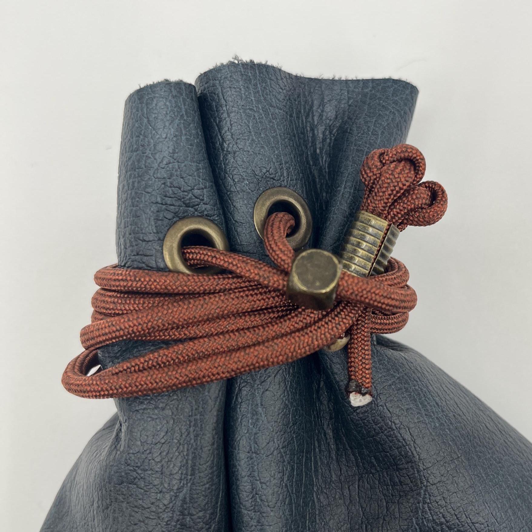 Handcrafted leather dice bag with drawstring, ideal for storing RPG dice sets. Perfect for DnD, tabletop games, or as a fantasy gift for gamers.