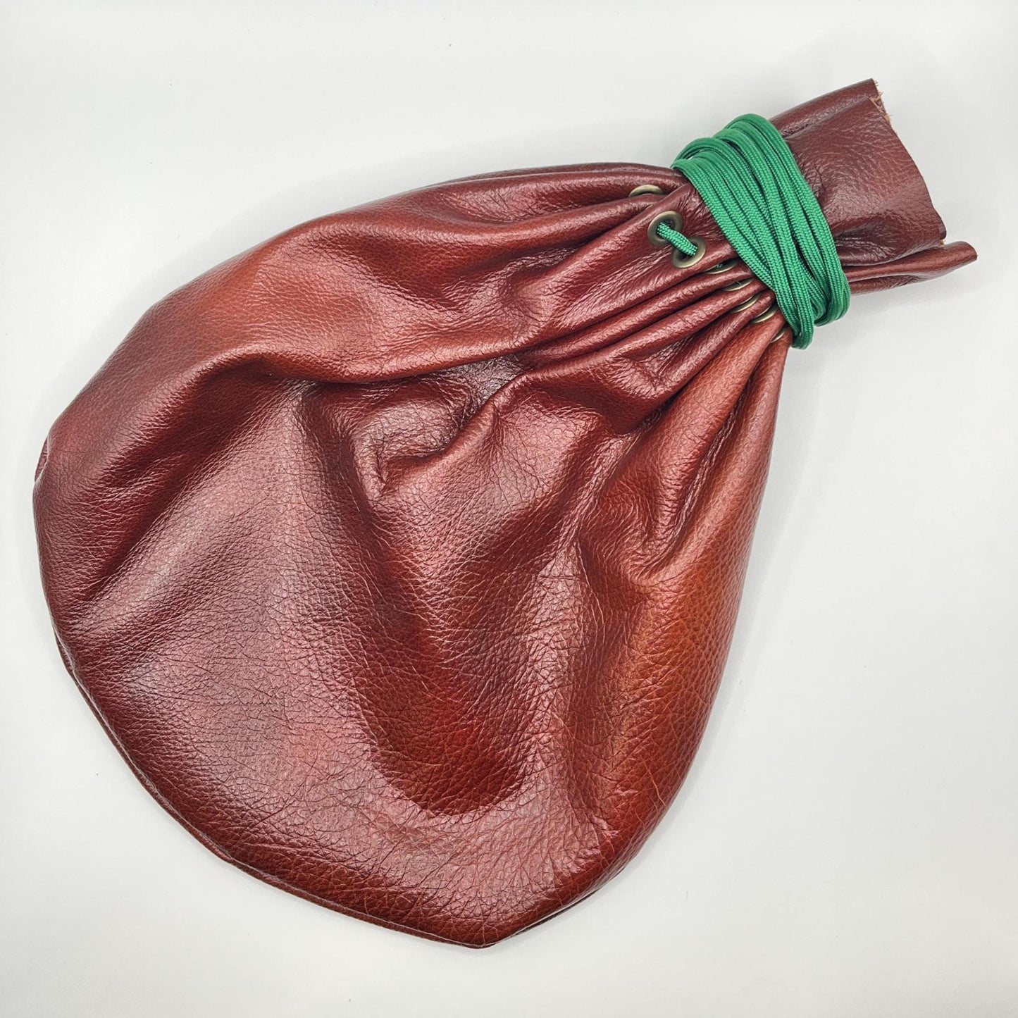 Handcrafted leather dice bag with drawstring, ideal for storing RPG dice sets. Perfect for DnD, tabletop games, or as a fantasy gift for gamers.