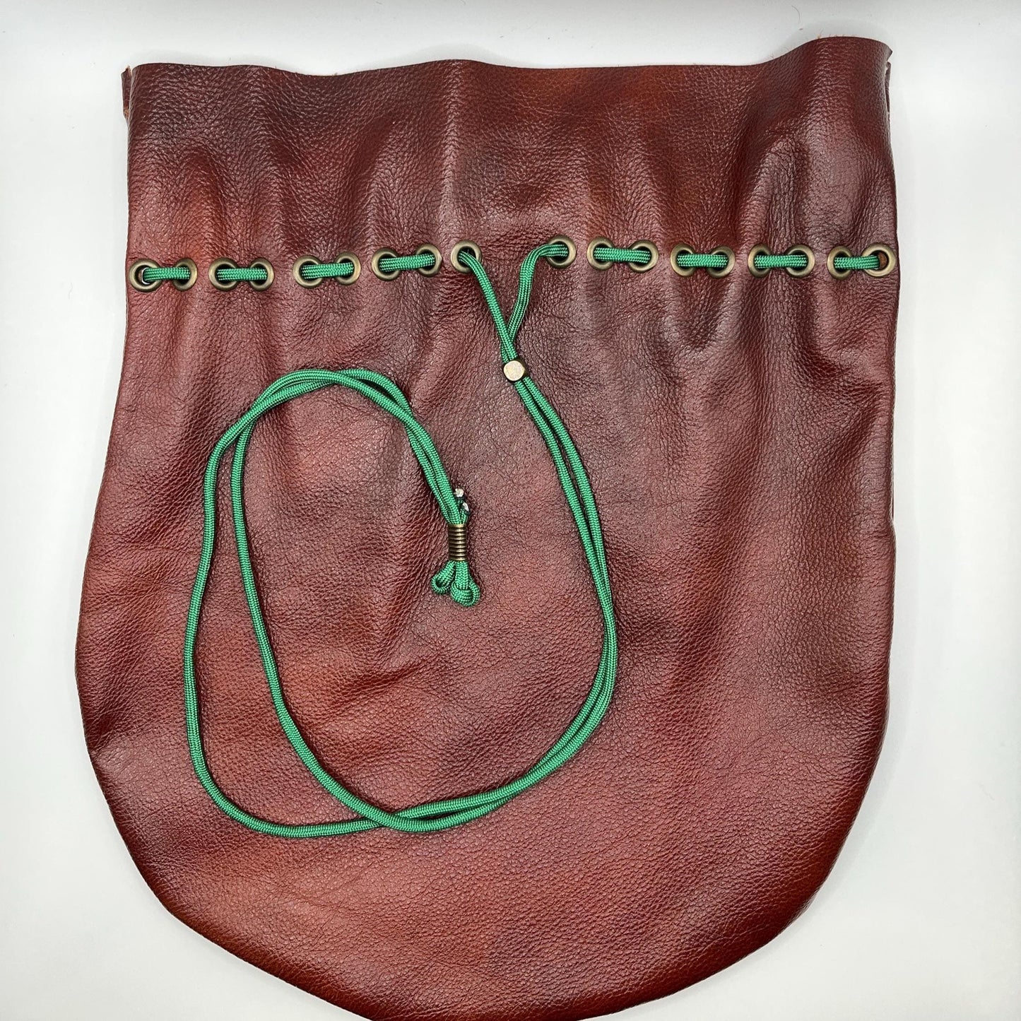 Handcrafted leather dice bag with drawstring, ideal for storing RPG dice sets. Perfect for DnD, tabletop games, or as a fantasy gift for gamers.