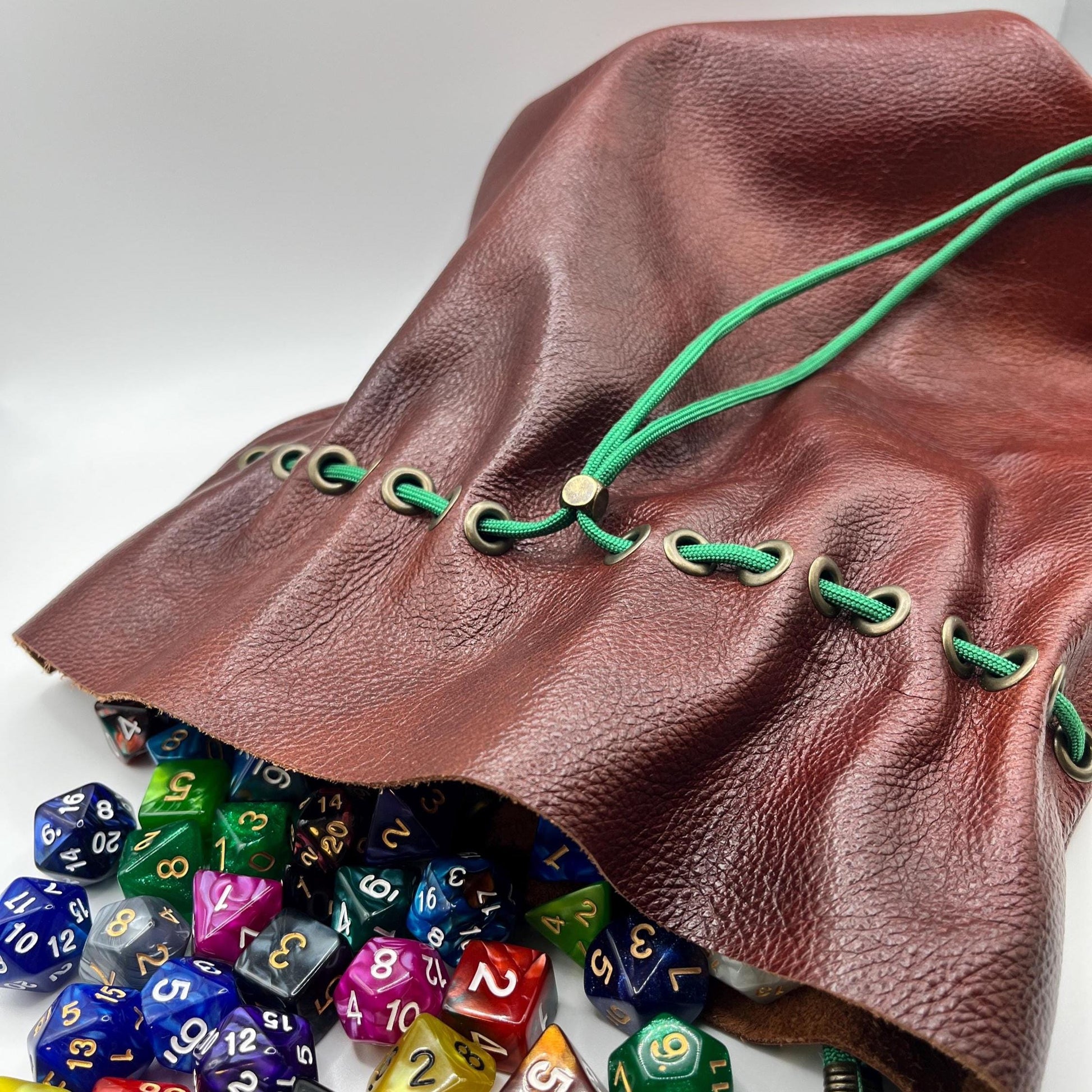 Handcrafted leather dice bag with drawstring, ideal for storing RPG dice sets. Perfect for DnD, tabletop games, or as a fantasy gift for gamers.