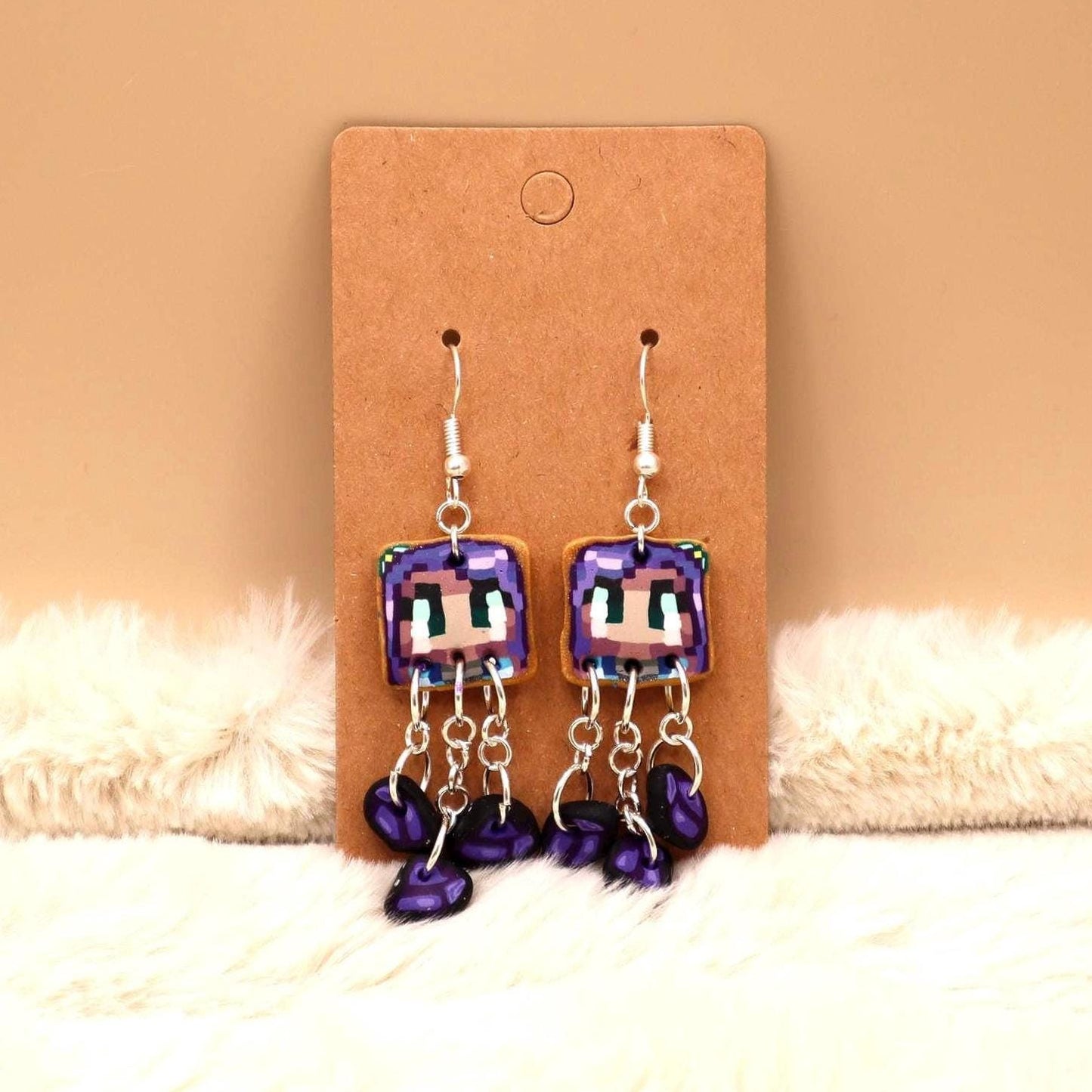 Handmade dangle earrings inspired by Abigail’s love of amethysts in Stardew Valley. Perfect gamer girl gift, cosplay jewelry, or crystal fan accessory.