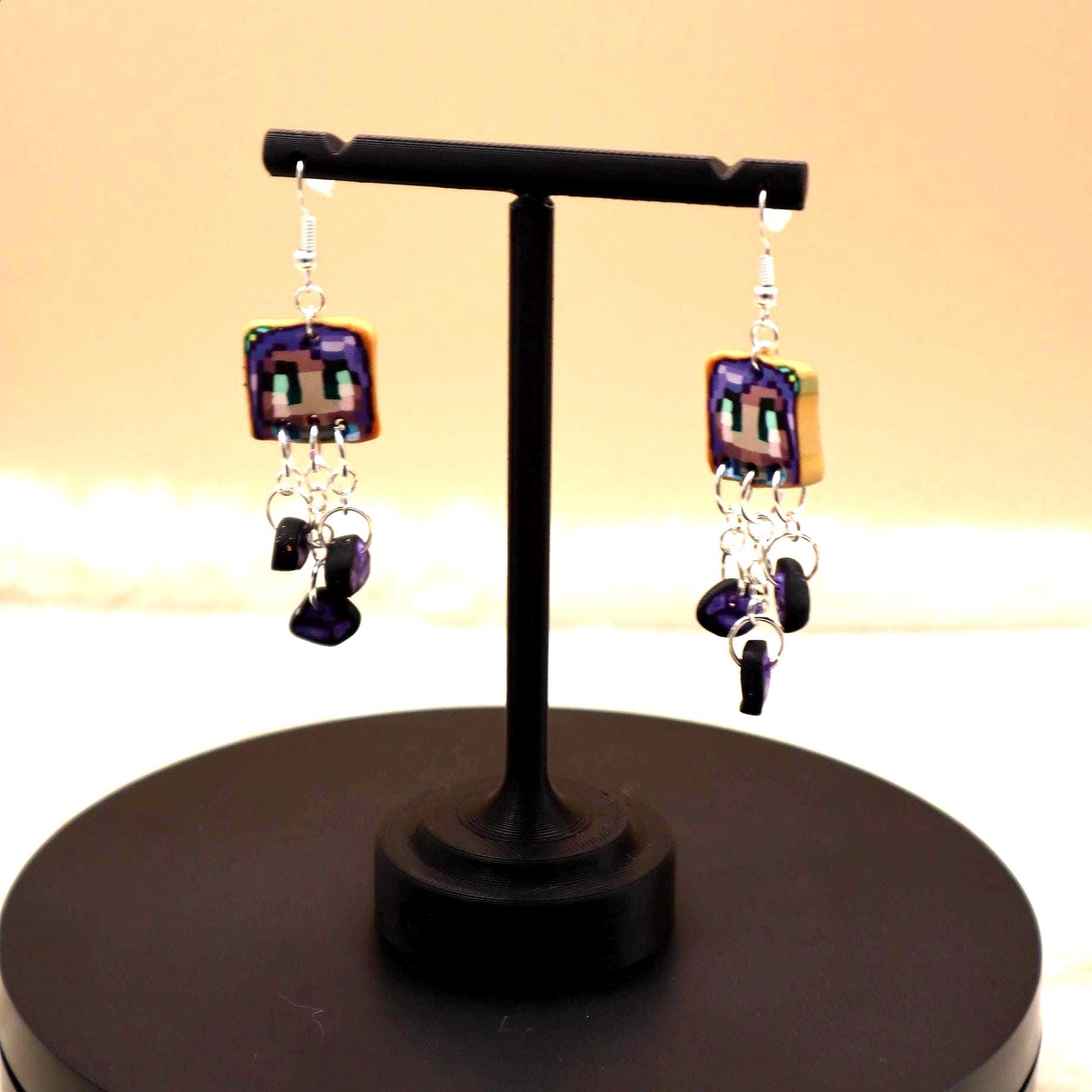 Handmade dangle earrings inspired by Abigail’s love of amethysts in Stardew Valley. Perfect gamer girl gift, cosplay jewelry, or crystal fan accessory.