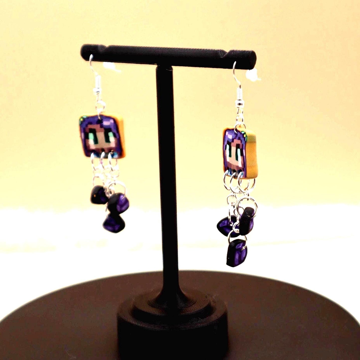 Handmade dangle earrings inspired by Abigail’s love of amethysts in Stardew Valley. Perfect gamer girl gift, cosplay jewelry, or crystal fan accessory.