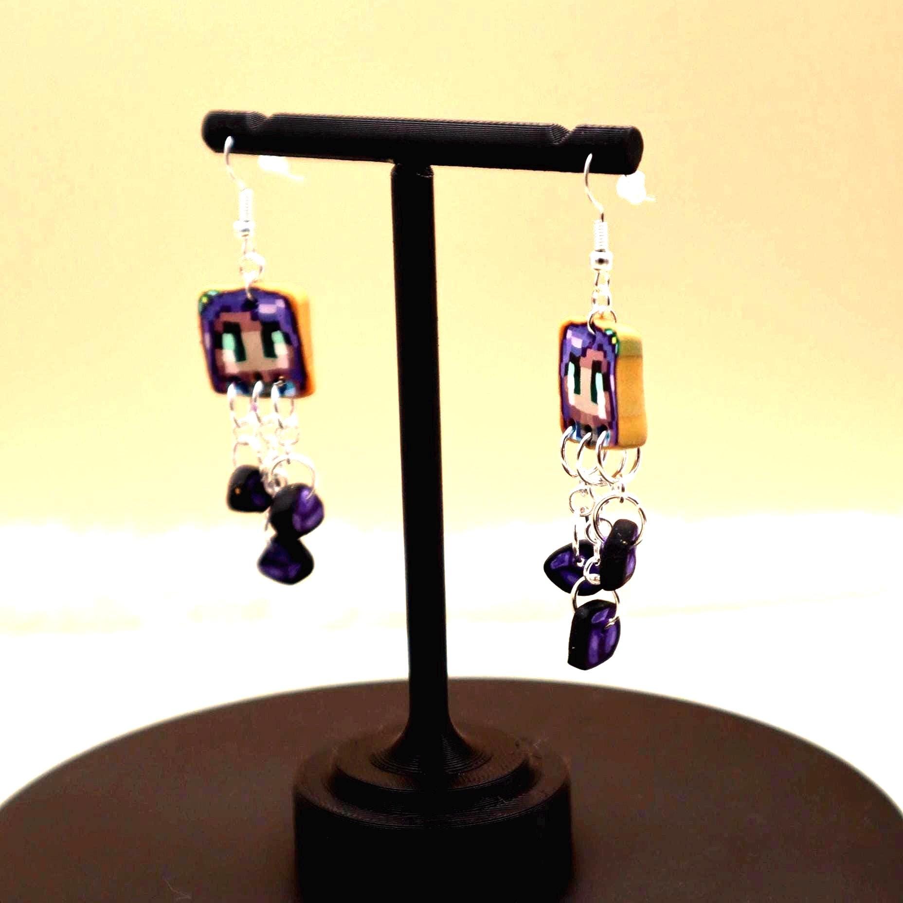 Handmade dangle earrings inspired by Abigail’s love of amethysts in Stardew Valley. Perfect gamer girl gift, cosplay jewelry, or crystal fan accessory.